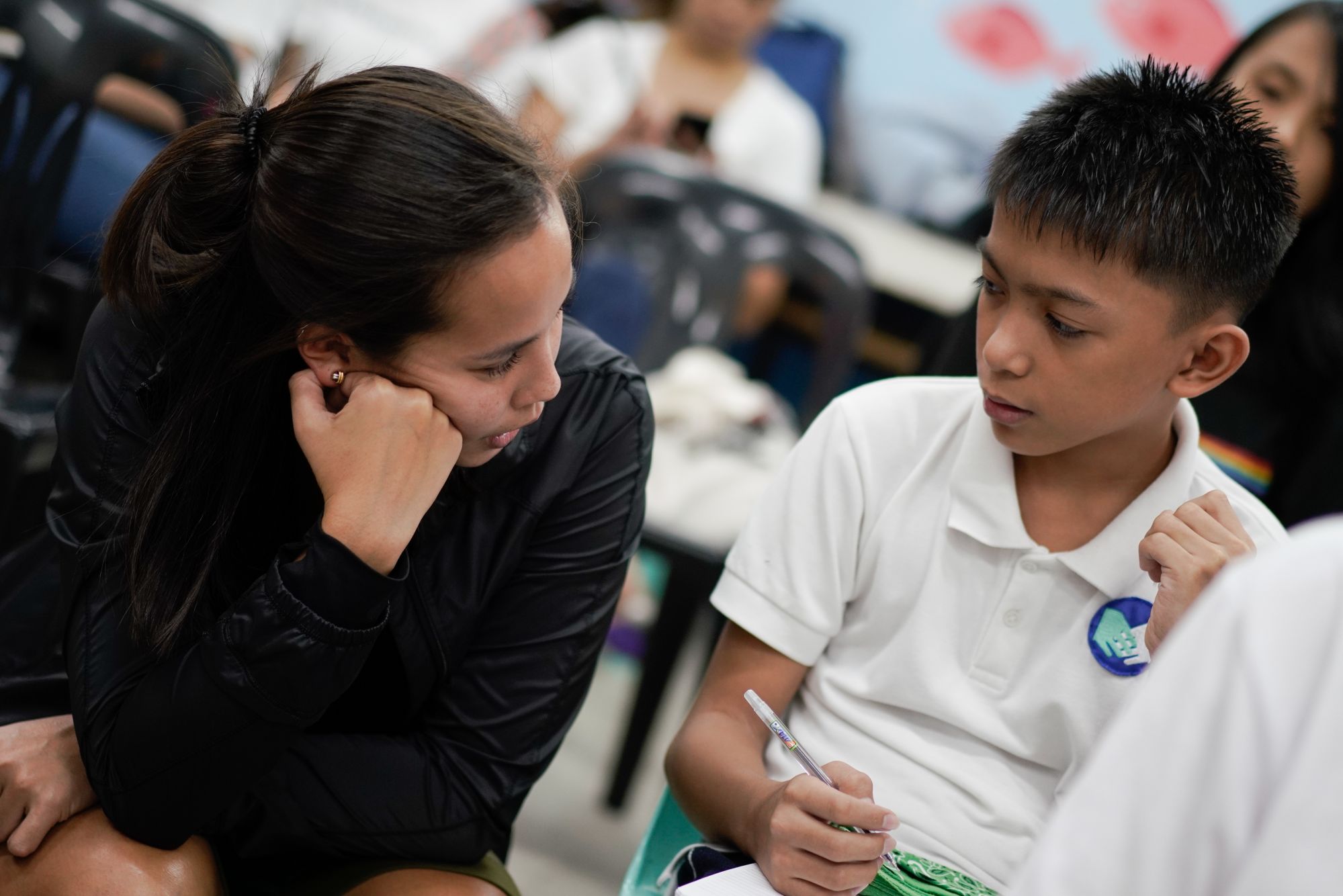 Dani De Los Reyes helping a student out with an activity