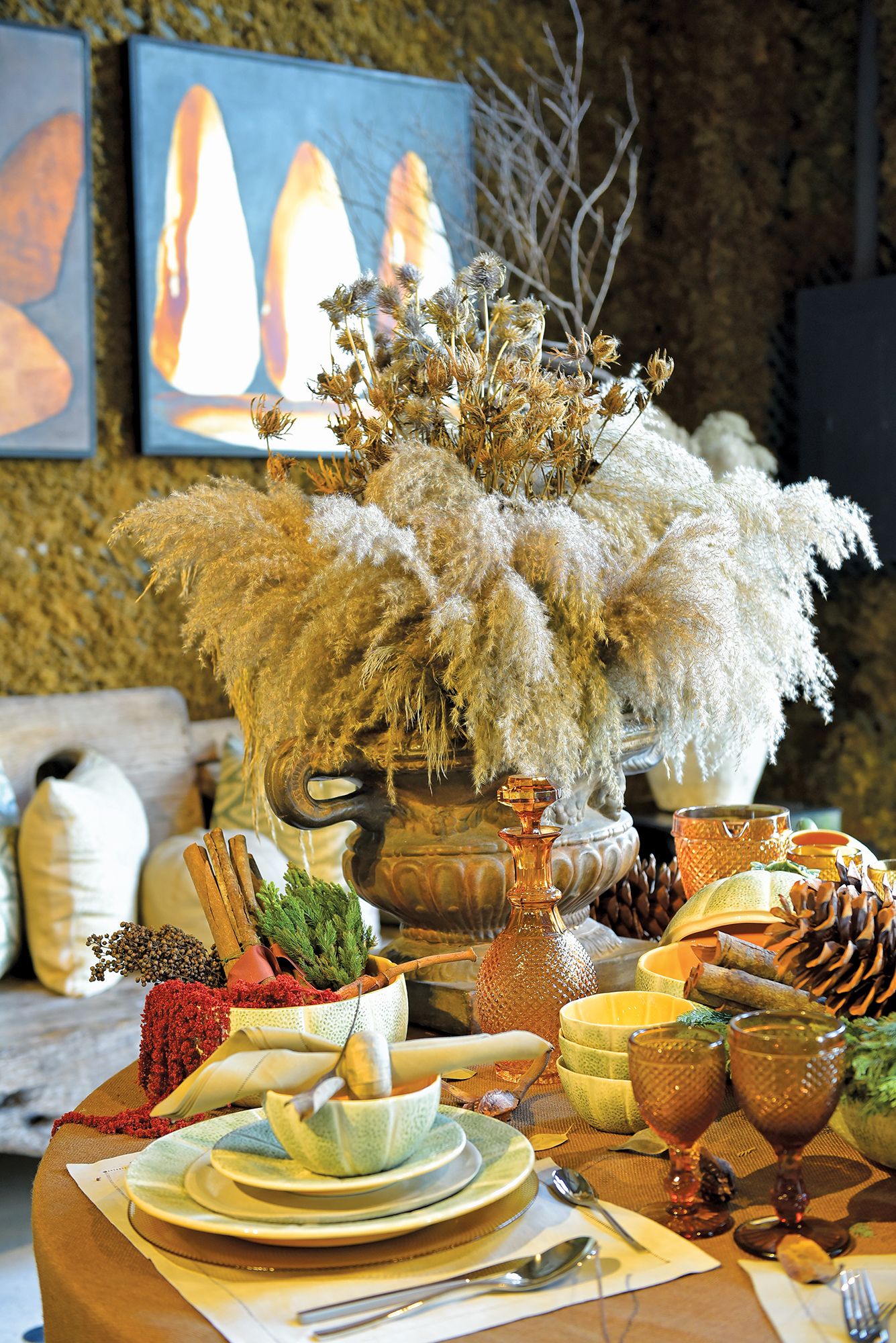 The Vidro Bordallo Pinheiro Melon dinnerware collection sits atop a table draped in burlap of the same earthen hues as the pinecones, cinnamon sticks, and rustic autumn leaf décor