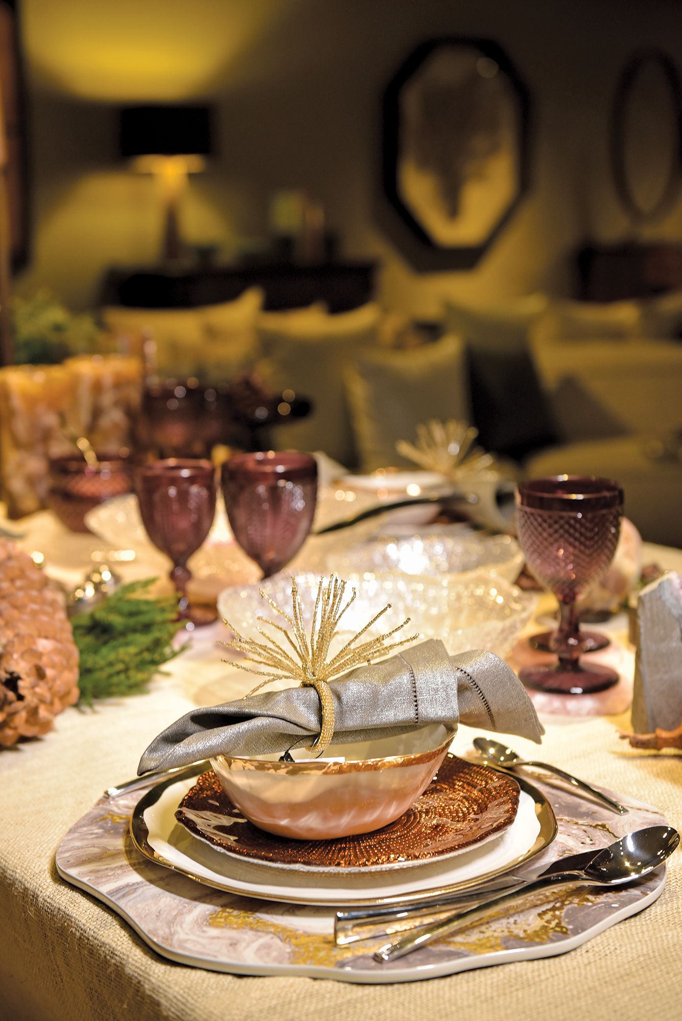 Kim Seybert beaded napkin rings and placemats in silver and gold complement the Mona bone china dinnerware and sparkling IVV Diamanté salad plates, adding a tasteful, festive flair