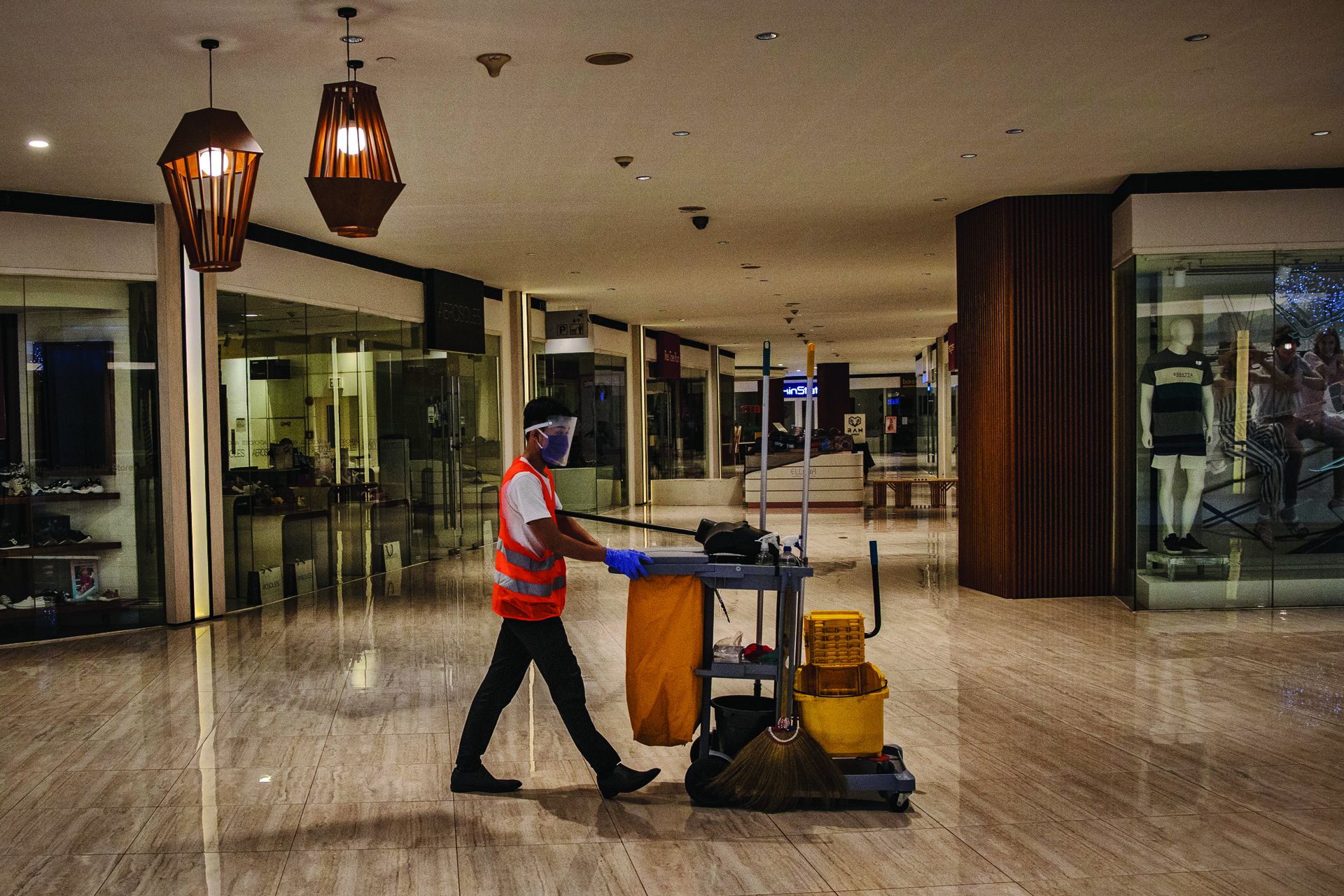 MANILA, PHILIPPINES - MAY 16: A cleaner is seen wearing a facemask and face shield at a mall on May 16, 2020 in Quezon city, Metro Manila, Philippines. The Philippine government began easing quarantine measures in many areas of the country, but has extended the lockdowns in Manila and a few other cities until May 31. Manilas lockdown, one of the worlds strictest, will extend to 80 days  longer than the 76-day lockdown of Wuhan, the Chinese city that was the early epicenter of COVID-19. The Philippines' Depa