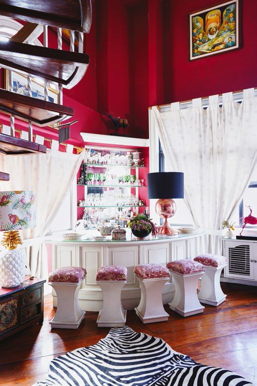 The open-plan design of this penthouse unit flows seamlessaly from the dining area to the living to the bar. Inspired by classic French and English country style but filled with the homeowners’ collections of decor and memorabilia, this space is a unique and ecclectic testmaent to personal style.