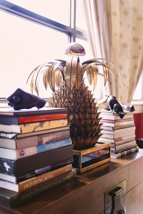 This 1950’s pineapple lamp found in a flea market in Spain is one of their many pineapple pieces. Next to it is a bronze cast of Abraham Lincoln’s hand holding a broom from their collection of political memorabilia.