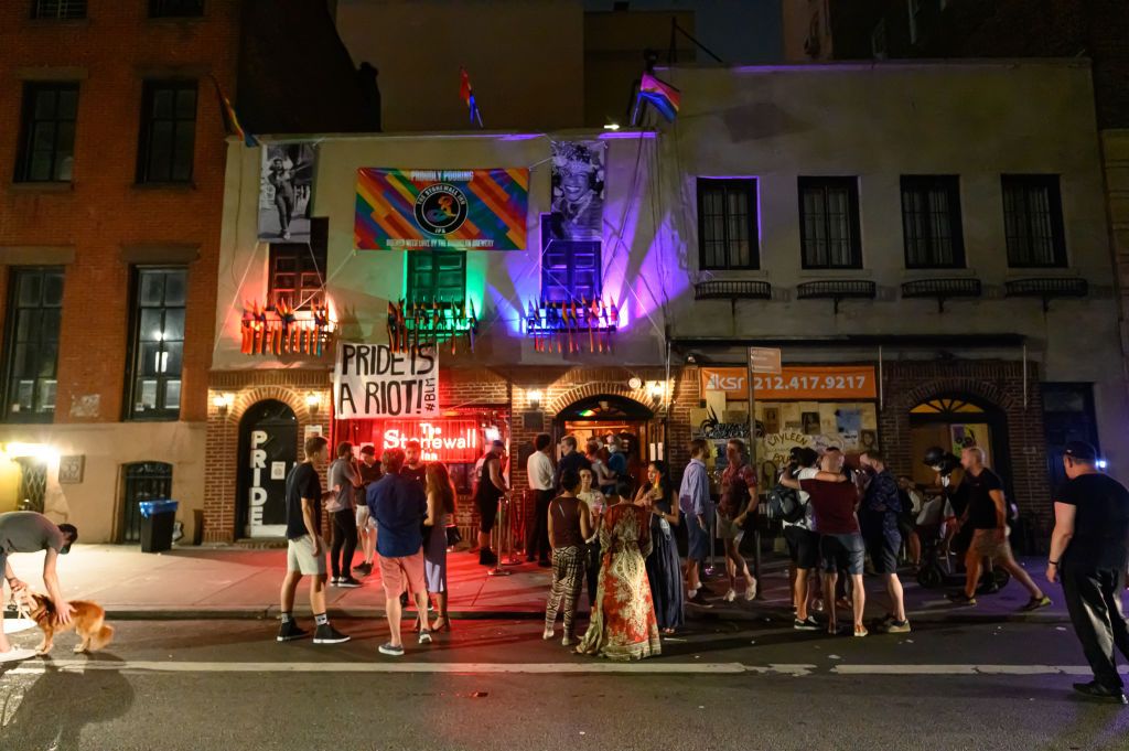 NEW YORK, NEW YORK - JUNE 27: People stand outside The Stonewall Inn in the West Village as New York City moves into Phase 2 of re-opening following restrictions imposed to curb the coronavirus pandemic on June 27, 2020. Phase 2 permits the reopening of offices, in-store retail, outdoor dining, barbers and beauty parlors and numerous other businesses. Phase 2 is the second of four-phased stages designated by the state. (Photo by Noam Galai/Getty Images)