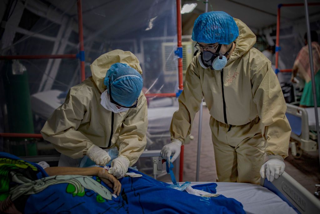 MANILA, PHILIPPINES - MAY 01: Medical personnel wearing protective clothing work to treat patients inside a tent at a parking lot converted into a COVID-19 isolation facility, at the National Kidney and Transplant Institute Hospital on May 1, 2020 in Quezon city, Metro Manila, Philippines. Parts of the Philippines, including the capital Manila, remain on lockdown as authorities continue to struggle with the growing number of COVID-19 cases. Land, sea, and air travels have been suspended, while government wo