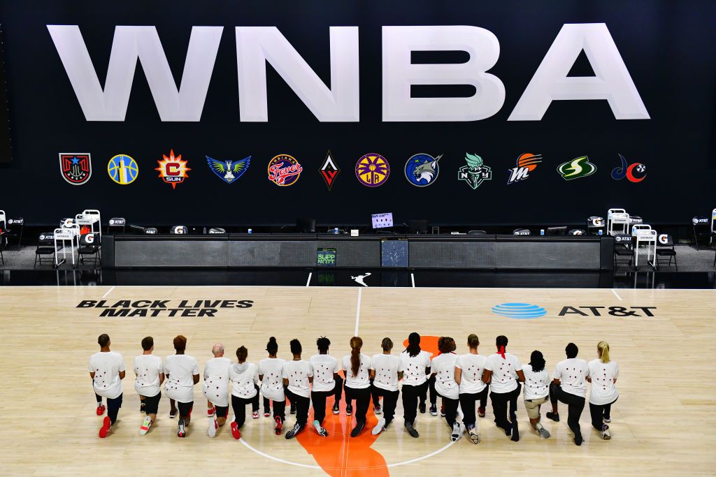 PALMETTO, FLORIDA - AUGUST 26: After the WNBA announcement of the postponed games for the evening, the Washington Mystics each wear white T-shirts with seven bullets on the back protesting the shooting of Jacob Blake by Kenosha, Wisconsin police at Feld Entertainment Center on August 26, 2020 in Palmetto, Florida. NOTE TO USER: User expressly acknowledges and agrees that, by downloading and or using this photograph, User is consenting to the terms and conditions of the Getty Images License Agreement. (Photo