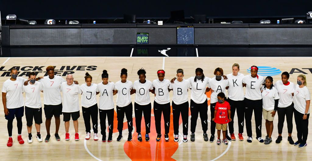 PALMETTO, FLORIDA - AUGUST 26: After the WNBA announcement of the postponed games for the evening, the Washington Mystics each wear white T-shirts with seven bullets on the back protesting the shooting of Jacob Blake by Kenosha, Wisconsin police at Feld Entertainment Center on August 26, 2020 in Palmetto, Florida. NOTE TO USER: User expressly acknowledges and agrees that, by downloading and or using this photograph, User is consenting to the terms and conditions of the Getty Images License Agreement. (Photo