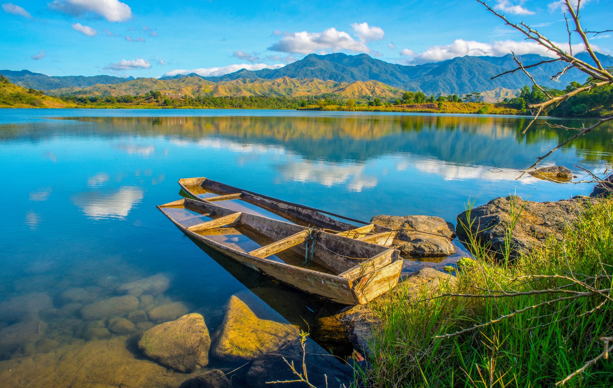 Stillness of water and idled boats surrounded by mountain ridge evokes a serenity by itself.