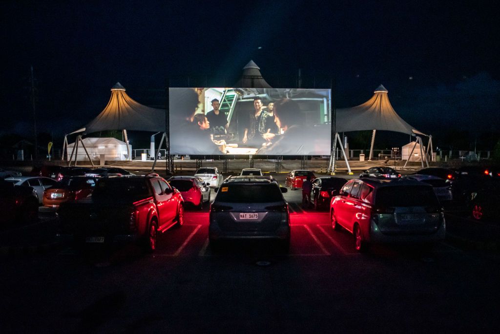 People watch a movie while inside their cars at a drive-in cinema in the province of Pampanga in Philippines on July 31, 2020. The drive-in cinema, with the capacity of about 90 cars, is the first to open in the country.(Photo by Lisa Marie David/NurPhoto via Getty Images)