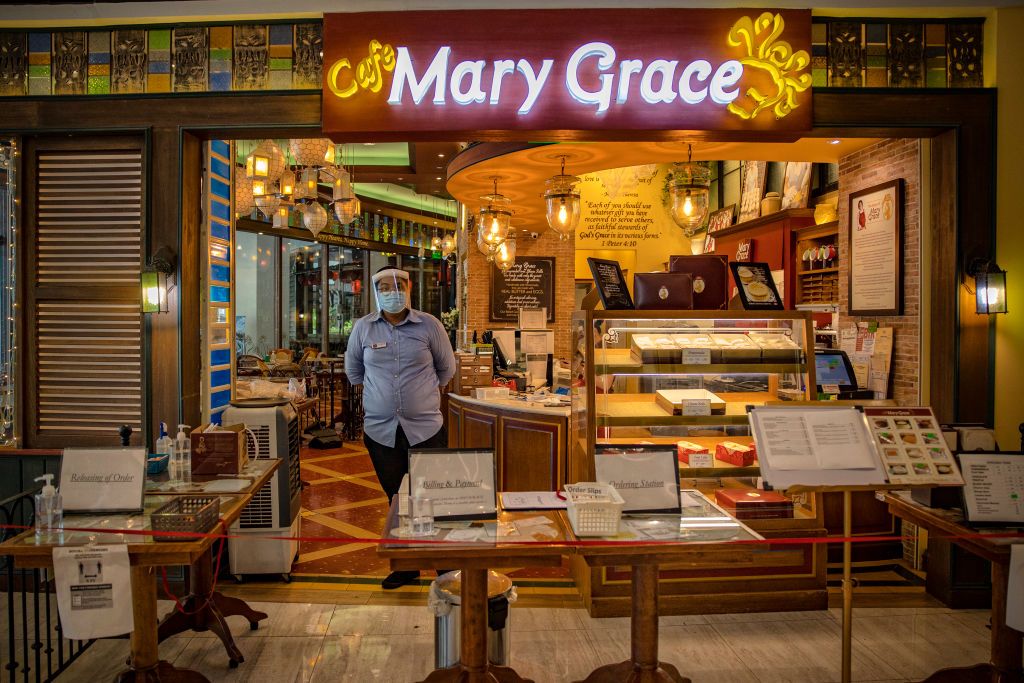MANILA, PHILIPPINES - MAY 16: A worker is seen wearing a face mask and face shield at a restaurant inside a mall on May 16, 2020 in Quezon city, Metro Manila, Philippines. The Philippine government began easing quarantine measures in many areas of the country, but has extended the lockdowns in Manila and a few other cities until May 31. Manilas lockdown, one of the worlds strictest, will extend to 80 days longer than the 76-day lockdown of Wuhan, the Chinese city that was the early epicenter of COVID-19. T
