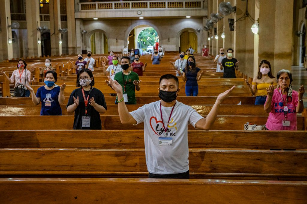 MANILA, PHILIPPINES - MAY 17: Worshippers wearing face masks stand far apart from one another to practice social distancing as they take part in Sunday service at a church on May 17, 2020 in Paranaque, Metro Manila, Philippines. The Philippines on Saturday began relaxing one of the world's longest and strictest lockdowns to curb the spread of the coronavirus. Lockdowns in Metro Manila and a few other provinces have been extended to 80 days, longer than the 76-day lockdown of Wuhan, the Chinese city that was