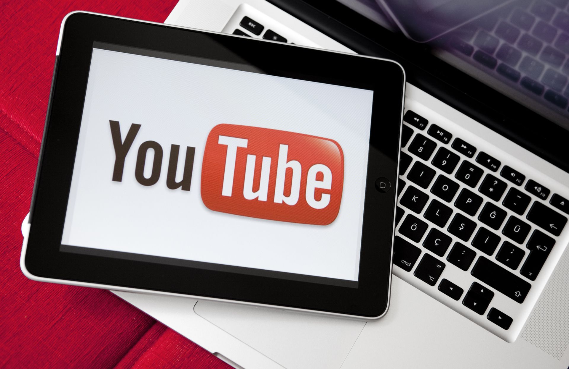 Antalya, Turkey - May 6, 2011: iPad is on the Apple Macbook Pro. Youtube logo on iPad screen. Youtube is the largest video sharing website in the world.