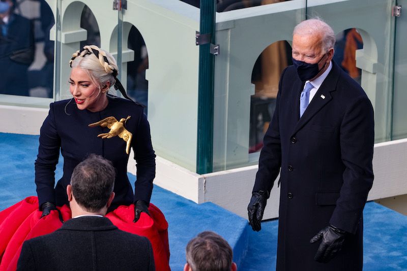 Lady Gaga reacts with President-elect Joe Biden after singing the National Anthem at Biden's inauguration on the West Front of the US Capitol on January 20, 2021 in Washington, DC. - During today's inauguration ceremony Joe Biden becomes the 46th president of the United States. (Photo by Tasos Katopodis / POOL / AFP)