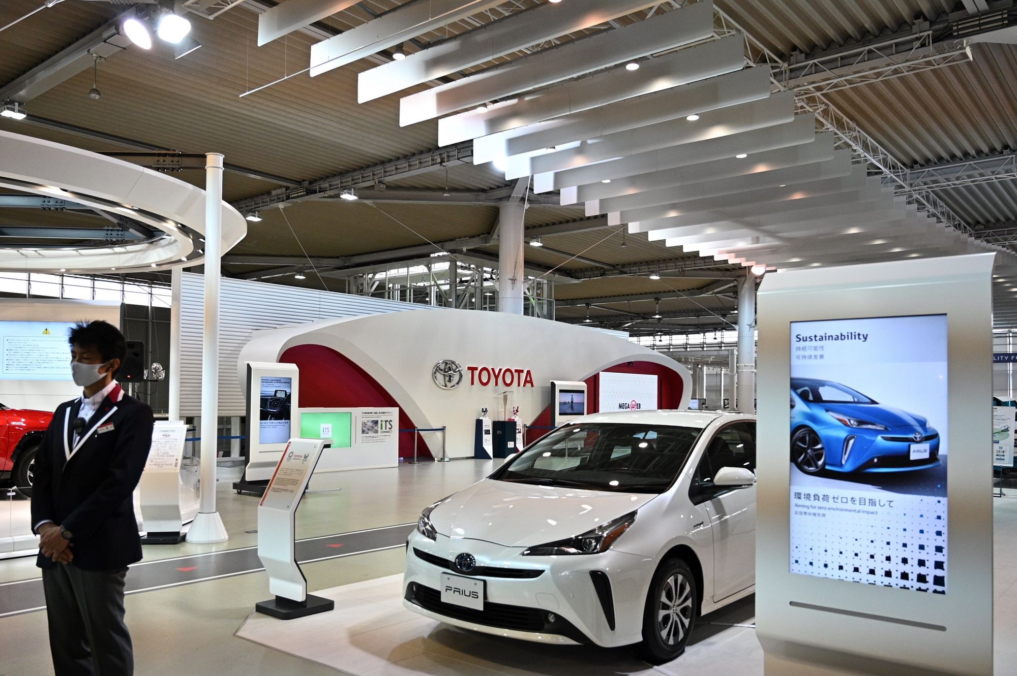 (FILES) In this file photo taken on November 6, 2020, a staff member stands in a Toyota showroom in Tokyo. - Japan's Toyota reclaimed the title of world's top-selling automaker in 2020, according to data released by the firm on January 28, 2021, pushing Volkswagen into second place for the first time in five years. (Photo by Philip FONG / AFP)