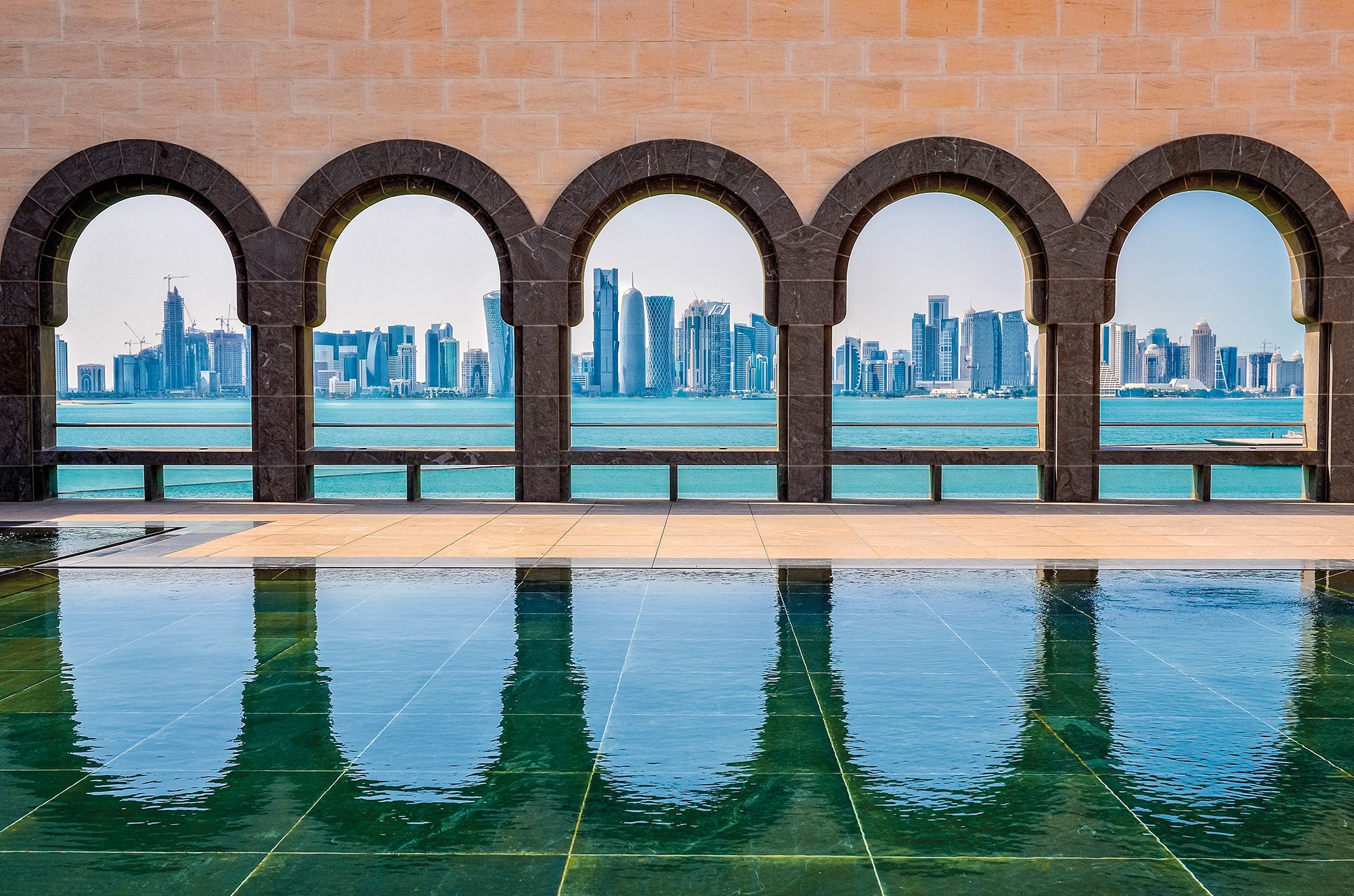 20197892 - doha skyline seen through the arches at the museum of islamic art, doha, qatar