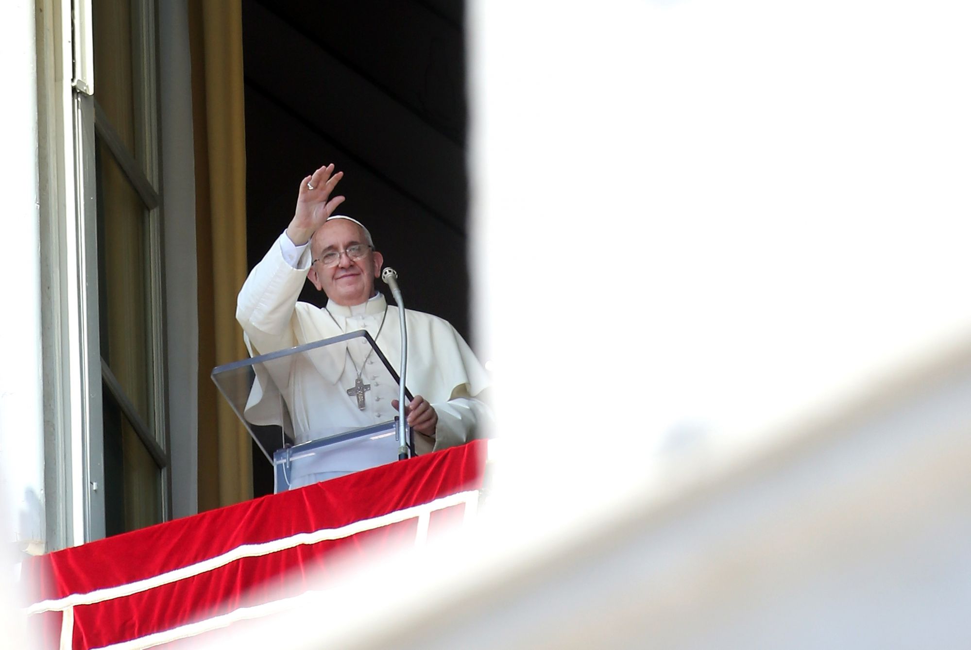 VATICAN CITY, VATICAN - AUGUST 10:  Pope Francis delivers his Angelus blessing from the window of the former Papal apartments overlooking St. Peter's Square on August 10, 2014 in Vatican City, Vatican.Pope Francis renewed his call for prayer and assistance for those suffering in Iraq. He also prayed for an end to the fighting between Israeli forces and Hamas militants in Gaza, as well as for the victims of the Ebola virus. Pope Francis will visit South Korea from August 14 to August 18.  (Photo by Franco Or