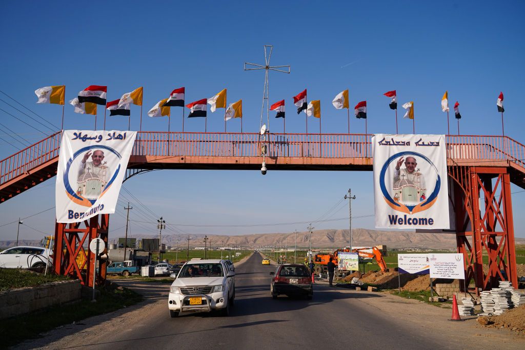 QARAQOSH, IRAQ - 2021/02/25: A view of a street decorated with Iraqi, Vatican flags and pictures of Pope Francis days before his historic visit to Iraq.The town of Qaraqosh, 30 kilometres southeast of the city of Mosul, is preparing to reception Pope Francis by renovating the church that the Pope will visit and by decorating the streets with the Vatican flags and pictures of the Pope on his first and historical visit to Iraq from March 5-8, his historical visit includes a trip to several cities, including