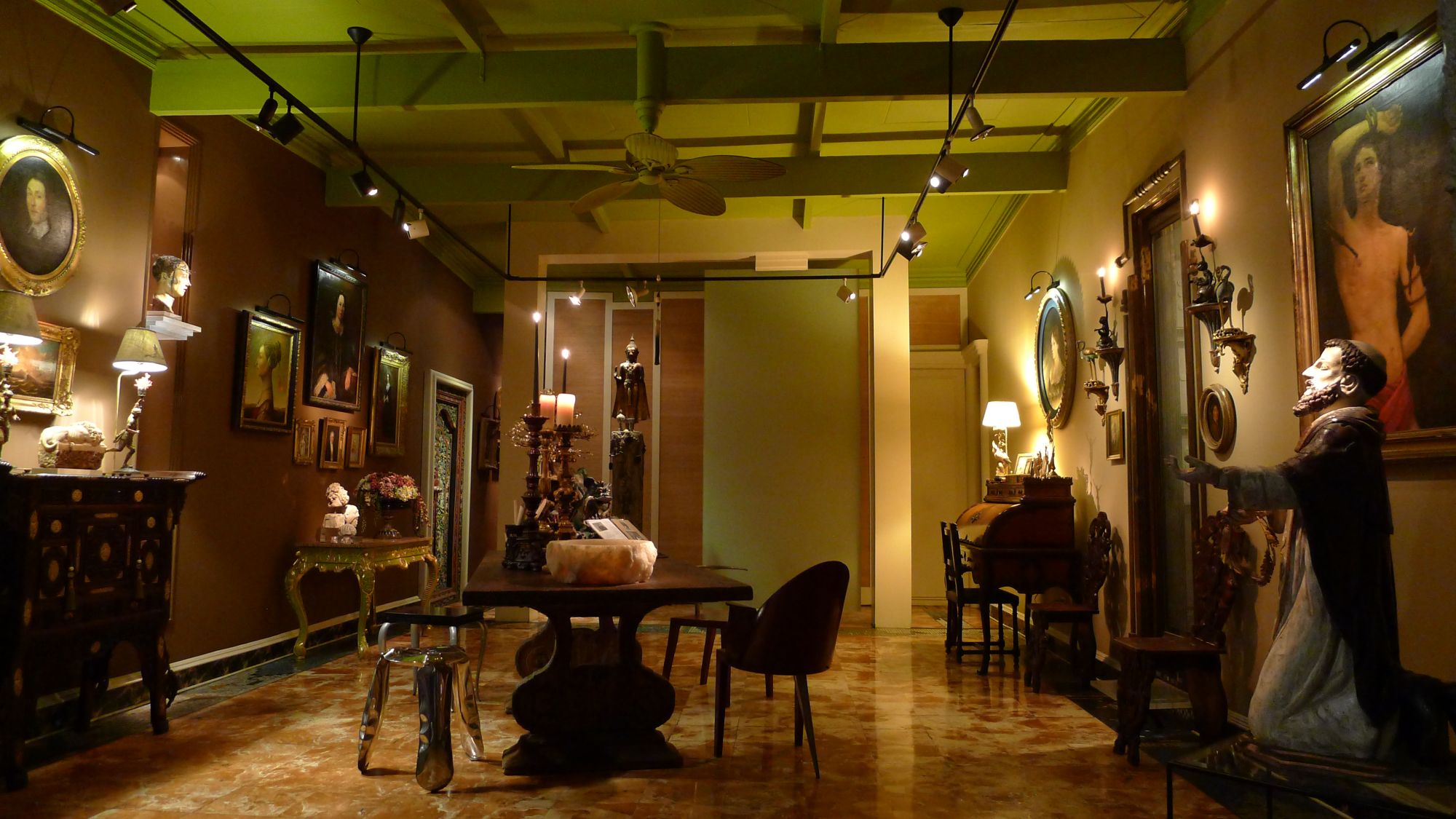 A photo from From Joyous Cross-Cultural Encounters, a chapter on the interiors of the authors’ home, which features a crying St John bust in a niche and a wall with portraits