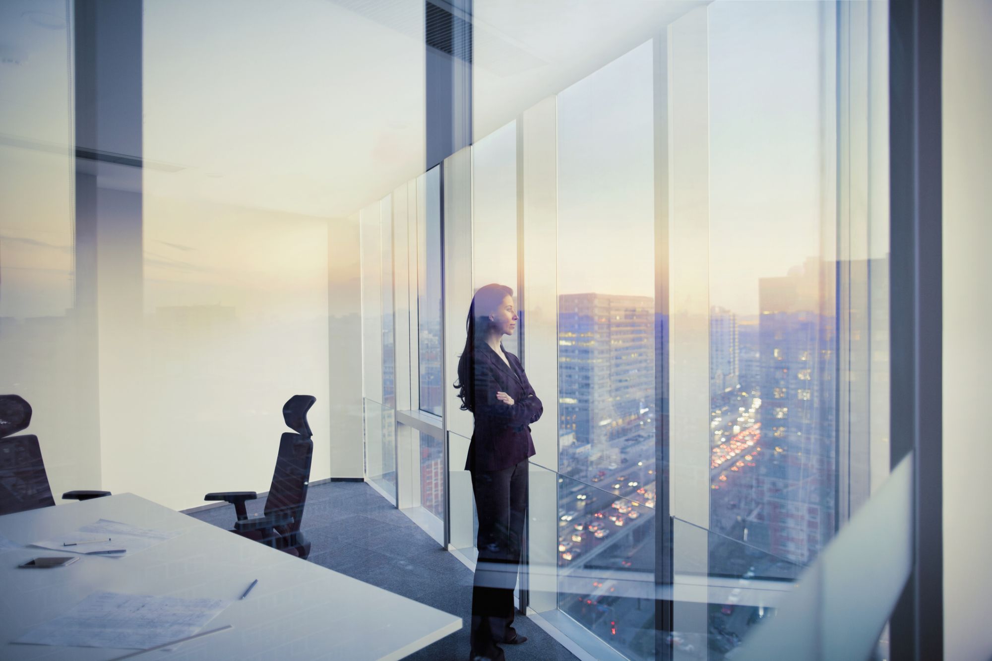 Adult Hispanic woman CEO executive  businesswoman business person in conference meeting room in contemporary modern office daylight sunset dusk talking planning thinking strategy well dressed suit diversity multi-ethnic problems solutions unity cityscape downtown urban new beginnings breaking new ground decisions choices the way forward  contemplation vision focus choices decisions solitude quiet alone