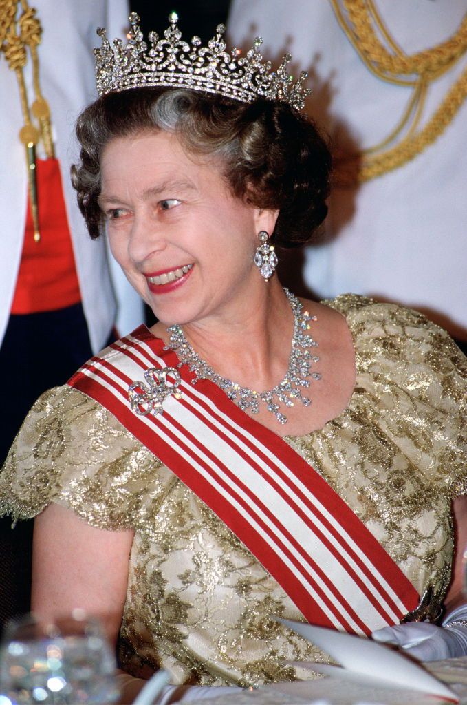 SINGAPORE - OCTOBER 10: Queen Elizabeth II At State Banquet. Her Diamond Tiara Was Made By Garrard Is Referred To As 'granny's Tiara' As It Was Originally A Wedding Gift To Queen Mary From The 'girls Of Great Britain And Ireland'. Fringe Necklace Of Drop Diamonds A Gift From King Khalid Of Saudi Arabia Worn With Diamond Bow Brooch. (Photo by Tim Graham Photo Library via Getty Images)