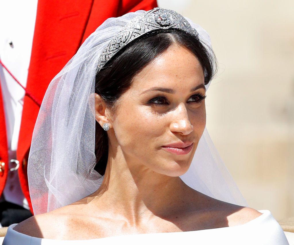 WINDSOR, UNITED KINGDOM - MAY 19: (EMBARGOED FOR PUBLICATION IN UK NEWSPAPERS UNTIL 24 HOURS AFTER CREATE DATE AND TIME) Meghan, Duchess of Sussex travels in an Ascot Landau carriage as she & Prince Harry, Duke of Sussex begin their procession through Windsor following their wedding at St George's Chapel, Windsor Castle on May 19, 2018 in Windsor, England. Prince Henry Charles Albert David of Wales marries Ms. Meghan Markle in a service at St George's Chapel inside the grounds of Windsor Castle. Among the g