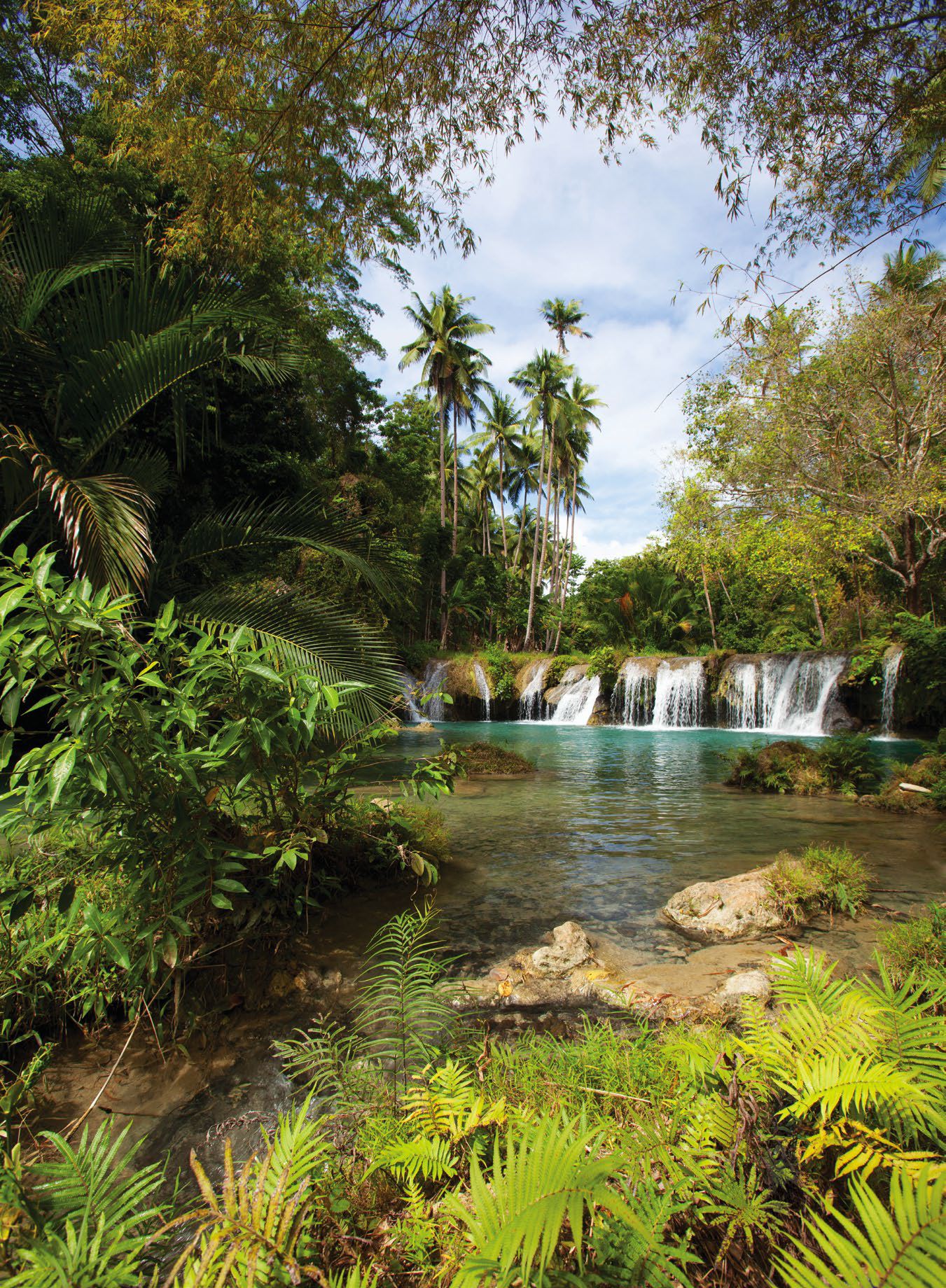 The cascading clear waters of Cambugahay Falls in the town of Lazi in Siquijor