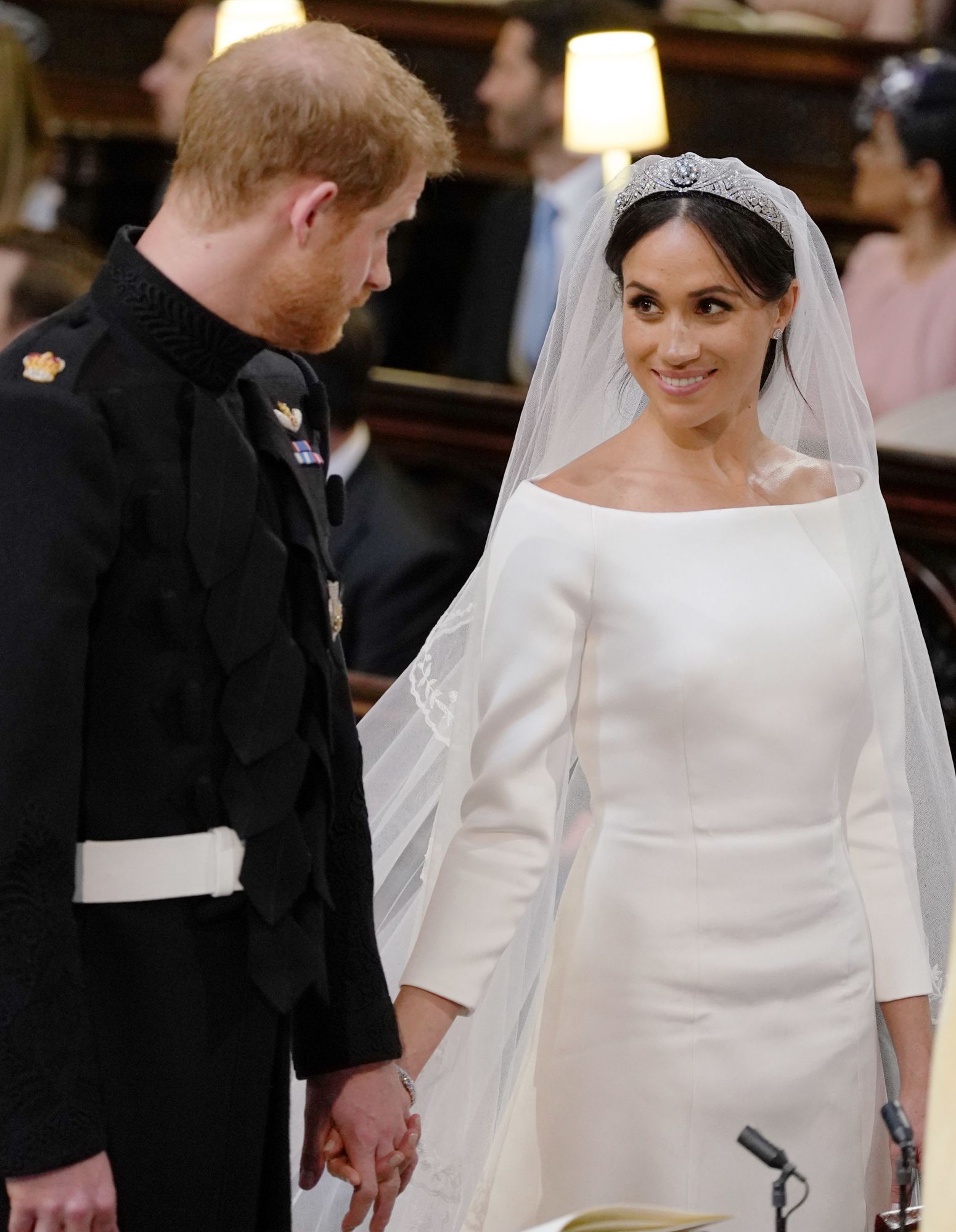WINDSOR, UNITED KINGDOM - MAY 19: Prince Harry and Meghan Markle look at each other during their wedding service in St George's Chapel at Windsor Castle on May 19, 2018 in Windsor, England. (Photo by Dominic Lipinski - WPA Pool/Getty Images)