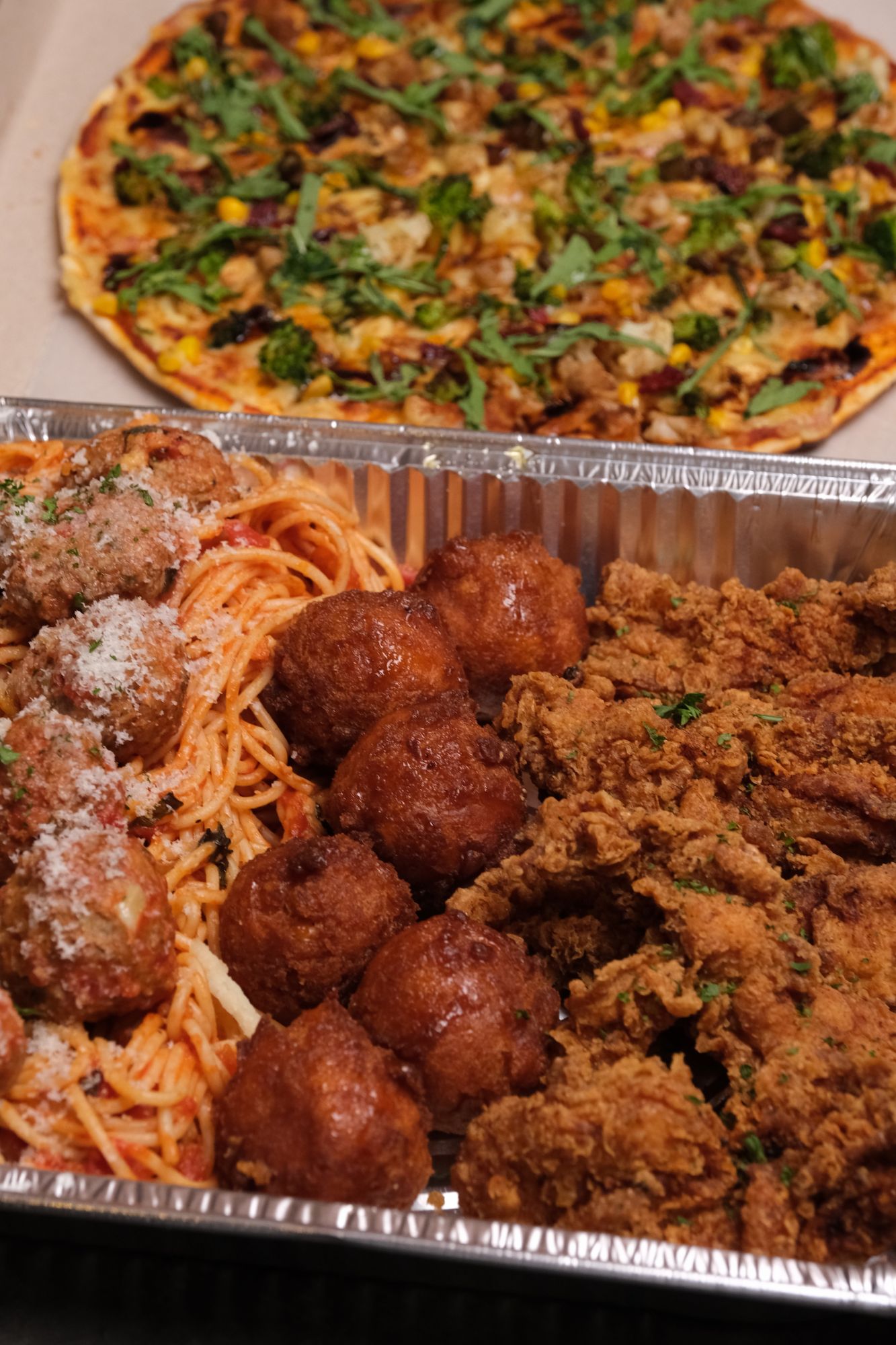 Fireside's fourth tray includes  fried chicken fingers, spaghetti and meatballs, cornbread doughnuts, and a pizza of your choice.