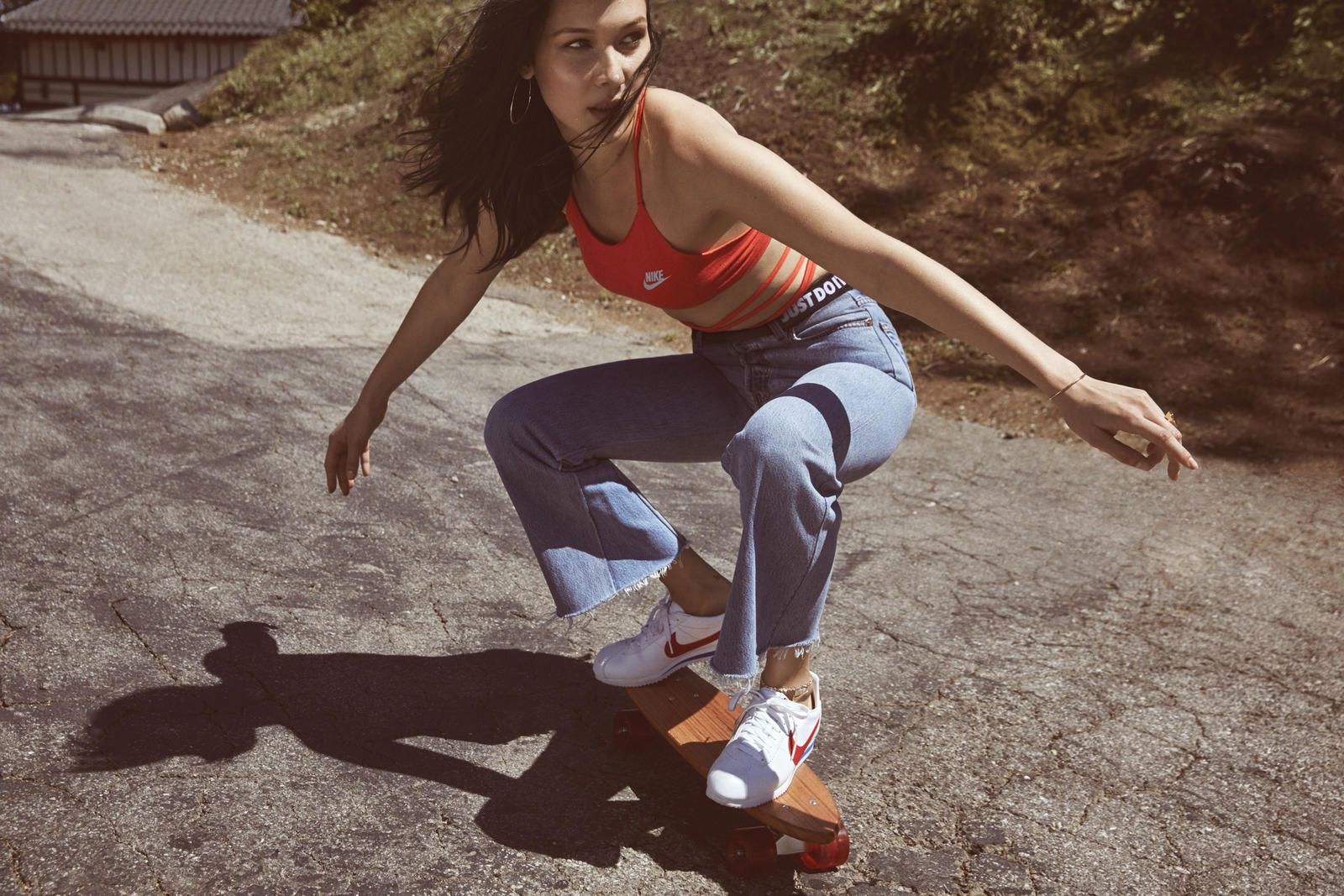 Bella Hadid wearing Nike Cortez in the style of Farrah Fawcett. | Photo: news.nike.com