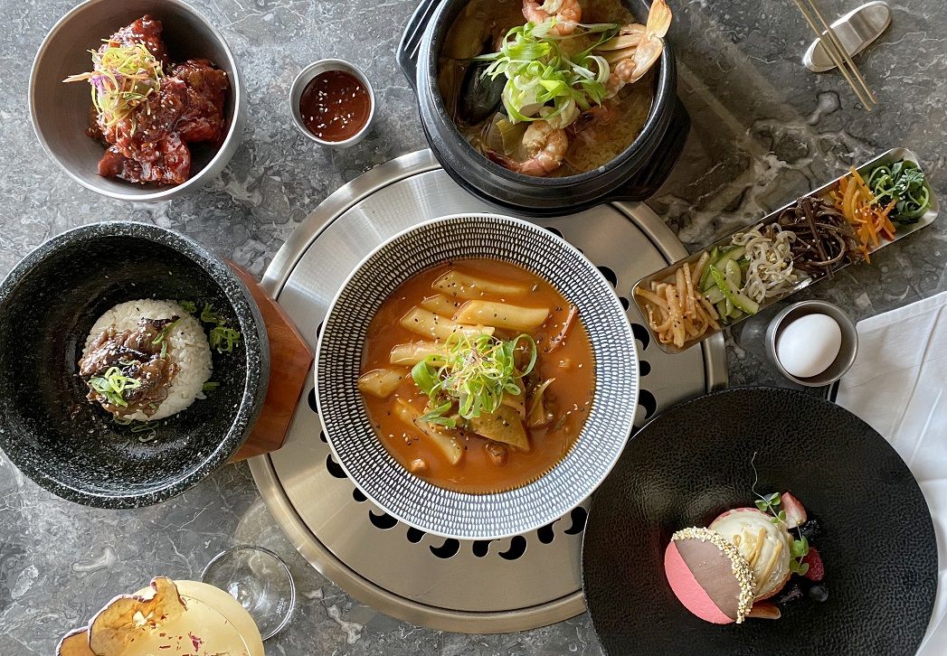 Bulgogi Bibimbap (sweet soy sauce marinated beef), Dakganjung (Korean fried chicken in sweet and spicy glaze), Tteok Bokki (rice and fish cake in sweet and spicy sauce), Haemul Denjang Jjigae (seafood with soybean paste), and Dulce Macaron Ice Cream Sandwich