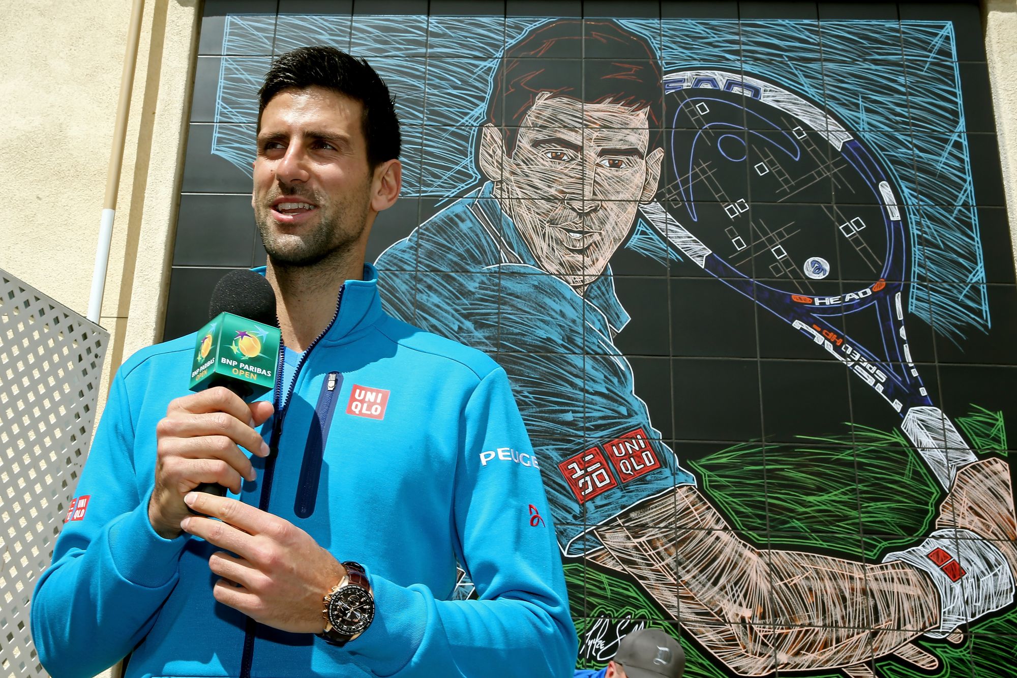 INDIAN WELLS, CA - MARCH 11: Novak Djokovic of Serbia addresses the crowd gathered at the unveiling of a mural in his likeness during the BNP Paribas Open at the Indian Wells Tennis Garden on March 11, 2016 in Indian Wells, California. (Photo by Matthew Stockman/Getty Images)