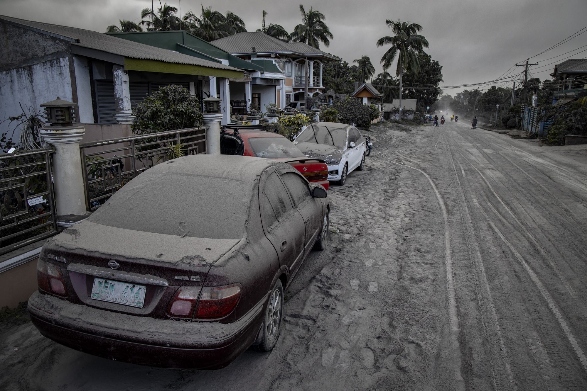 LEMERY, PHILIPPINES - JANUARY 13: Vehicles covered in volcanic ash from Taal Volcano's eruption are seen on January 13, 2020 in Lemery, Batangas province, Philippines. The Philippine Institute of Volcanology and Seismology raised the alert level to four out of five, warning that a hazardous eruption could take place anytime, as Manila's international airport suspended flights and authorities began evacuating tens of thousands of people from the area. (Photo by Ezra Acayan/Getty Images)