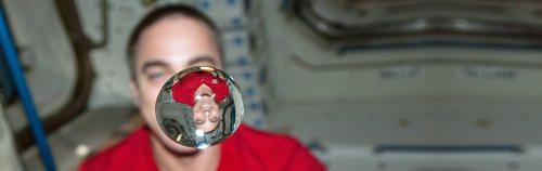 NASA astronaut Chris Cassidy, Expedition 36 flight engineer, watches a water bubble float freely between him and the camera, showing his image refracted, in the Unity node of the International Space Station. | Photo: NASA