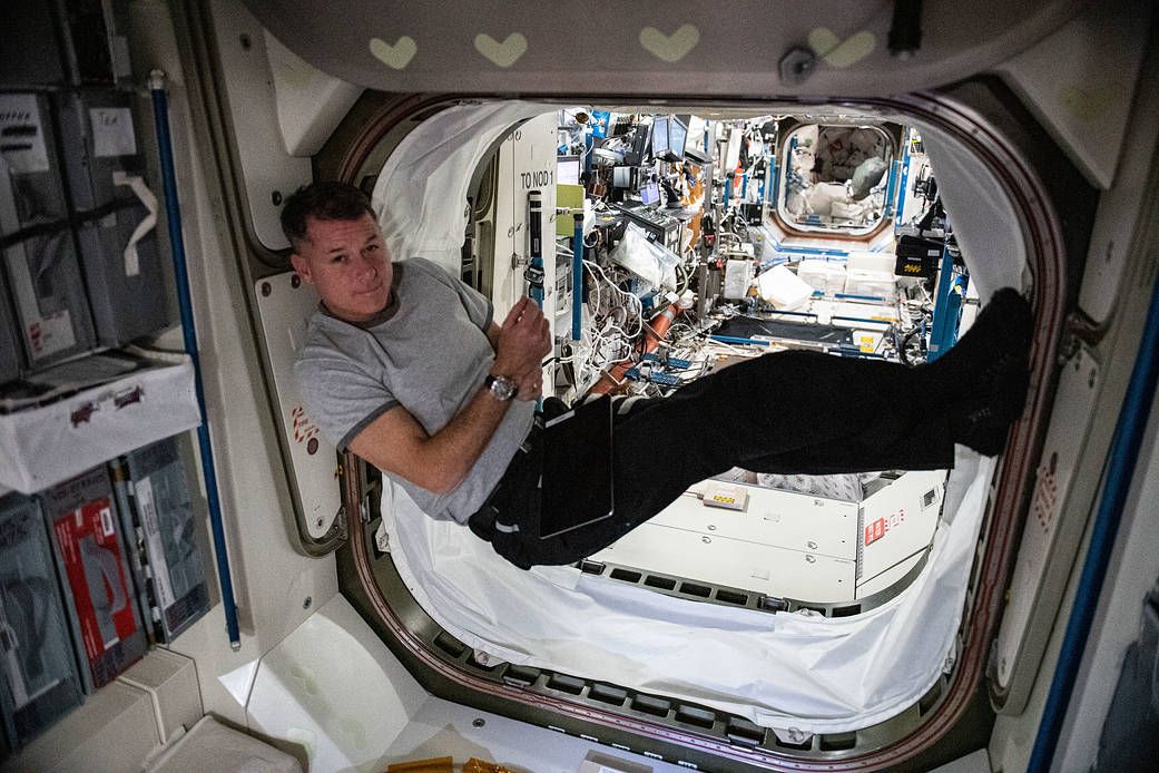NASA astronaut and Expedition 65 Flight Engineer Shane Kimbrough rests inside the vestibule in between the Unity module and the U.S. Destiny laboratory module. | Photo: NASA