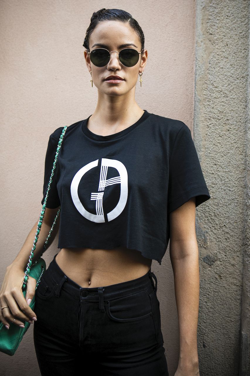 MILAN, ITALY - JUNE 17: Model Sofia Resing, wearing a black printed crop top, black jeans and green bag, is seen outside Giorgio Armani show, during the Milan Men's Fashion Week Spring/Summer 2020 on June 17, 2019 in Milan, Italy. (Photo by Claudio Lavenia/Getty Images)