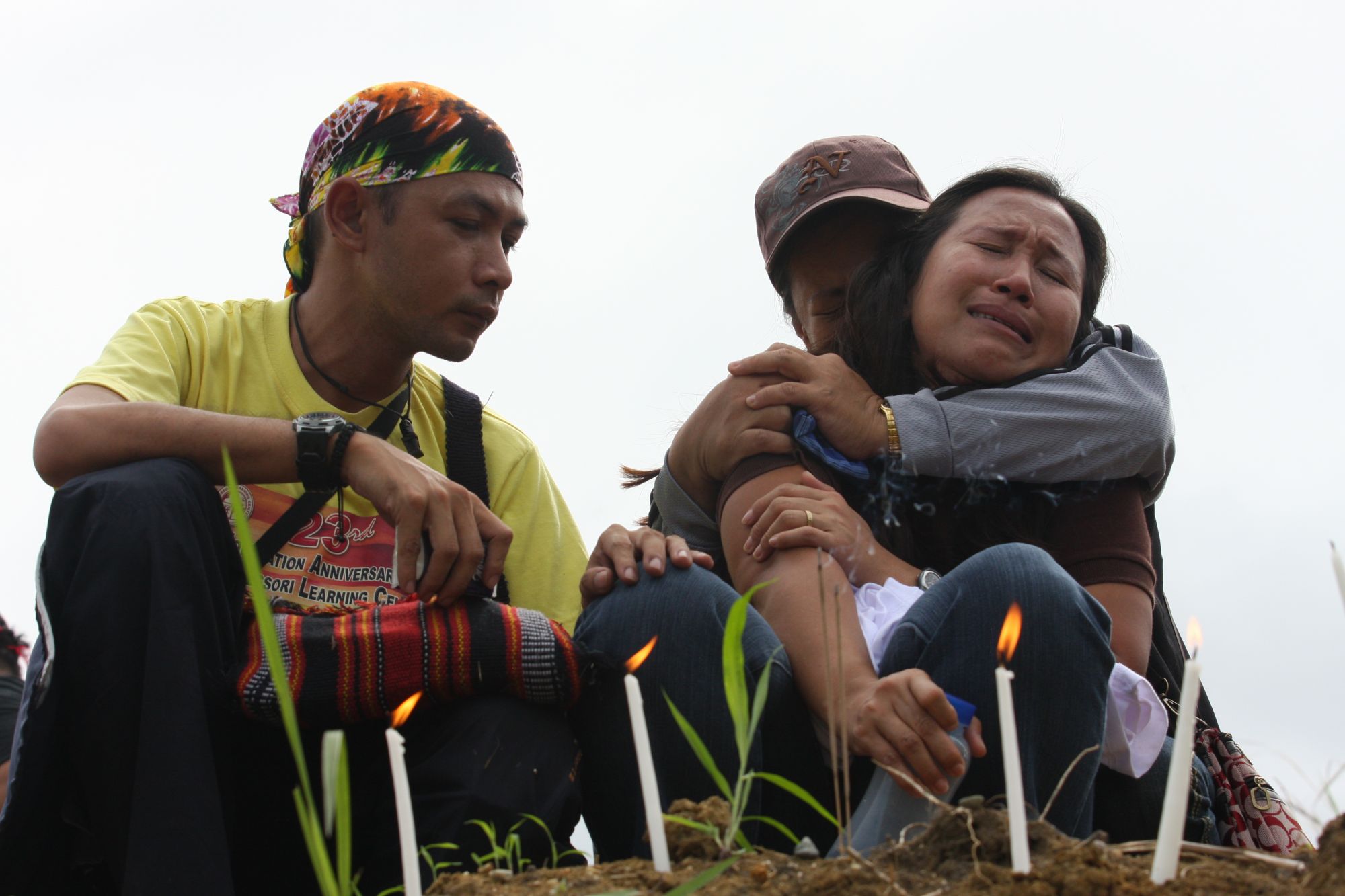 MAGUINDANAO PROVINCE, PHILIPPINES - JANUARY 23: Family members mourn relatives who were among the 57 people killed in a massacre on November 23, 2009 at the site of massacre on January 23, 2010 in the township of Ampatuan, Maguindanao Province, Philippines. Hundreds of people, including groups of journalists and peace advocates, gathered at the site of the recent massacre in the township of Ampatuan. They formed together in remembrance and as a collective expression of outrage against the killings of jour