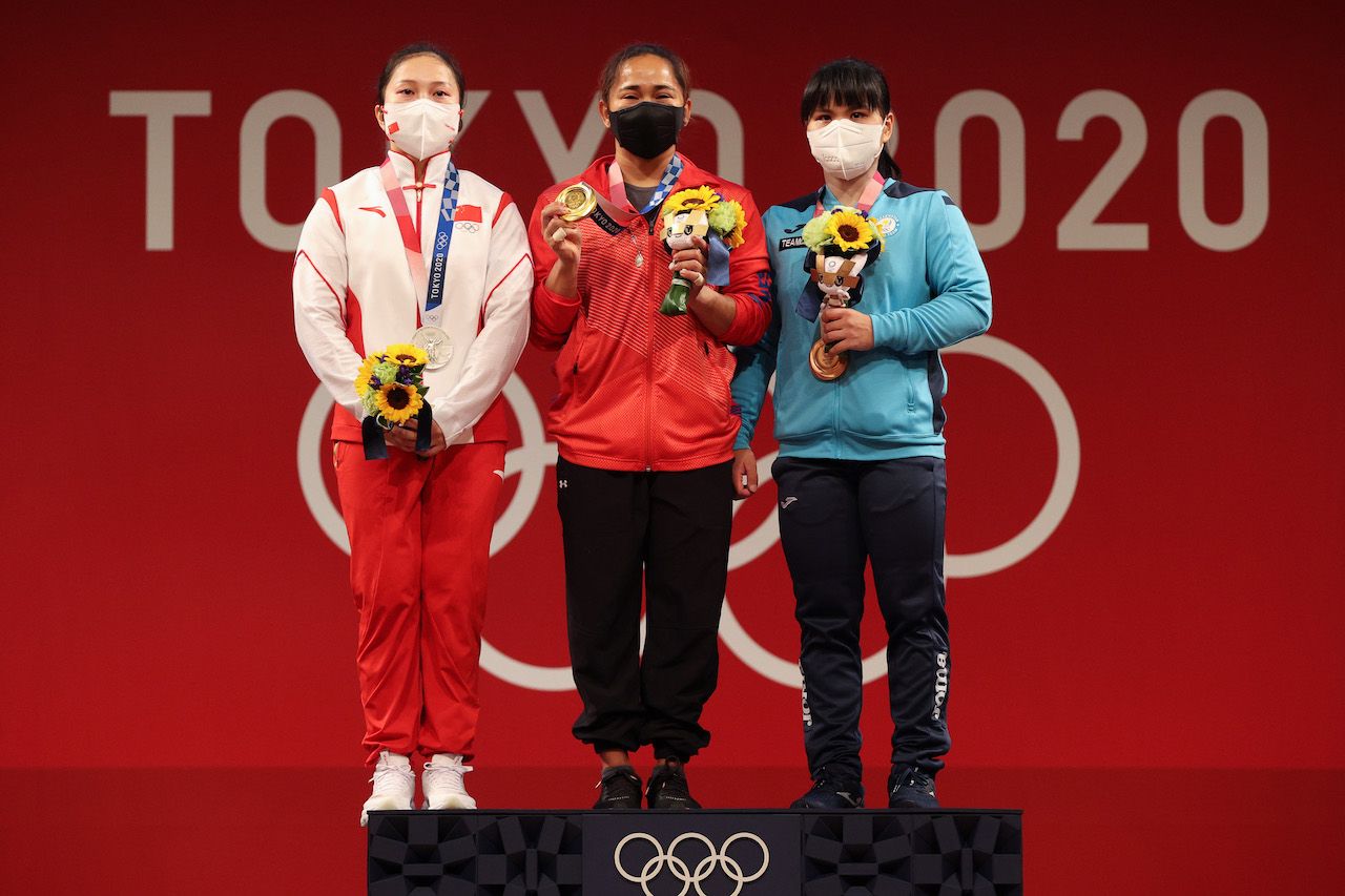 TOKYO, JAPAN - JULY 26: (L-R) Silver medalist Qiuyun Liao of Team China, gold medalist Hidilyn Diaz of Team Philippines and bronze medalist Zulfiya Chinshanlo of Team Kazakhstan pose during the medal ceremony for the Weightlifting - Women's 55kg Group A on day three of the Tokyo 2020 Olympic Games at Tokyo International Forum on July 26, 2021 in Tokyo, Japan. (Photo by Chris Graythen/Getty Images)