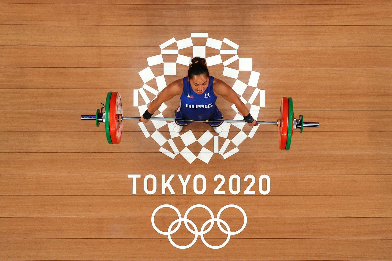 TOKYO, JAPAN - JULY 26: Hidilyn Diaz of Team Philippines competes during the Weightlifting - Women's 55kg Group A on day three of the Tokyo 2020 Olympic Games at Tokyo International Forum on July 26, 2021 in Tokyo, Japan. (Photo by Chris Graythen/Getty Images)