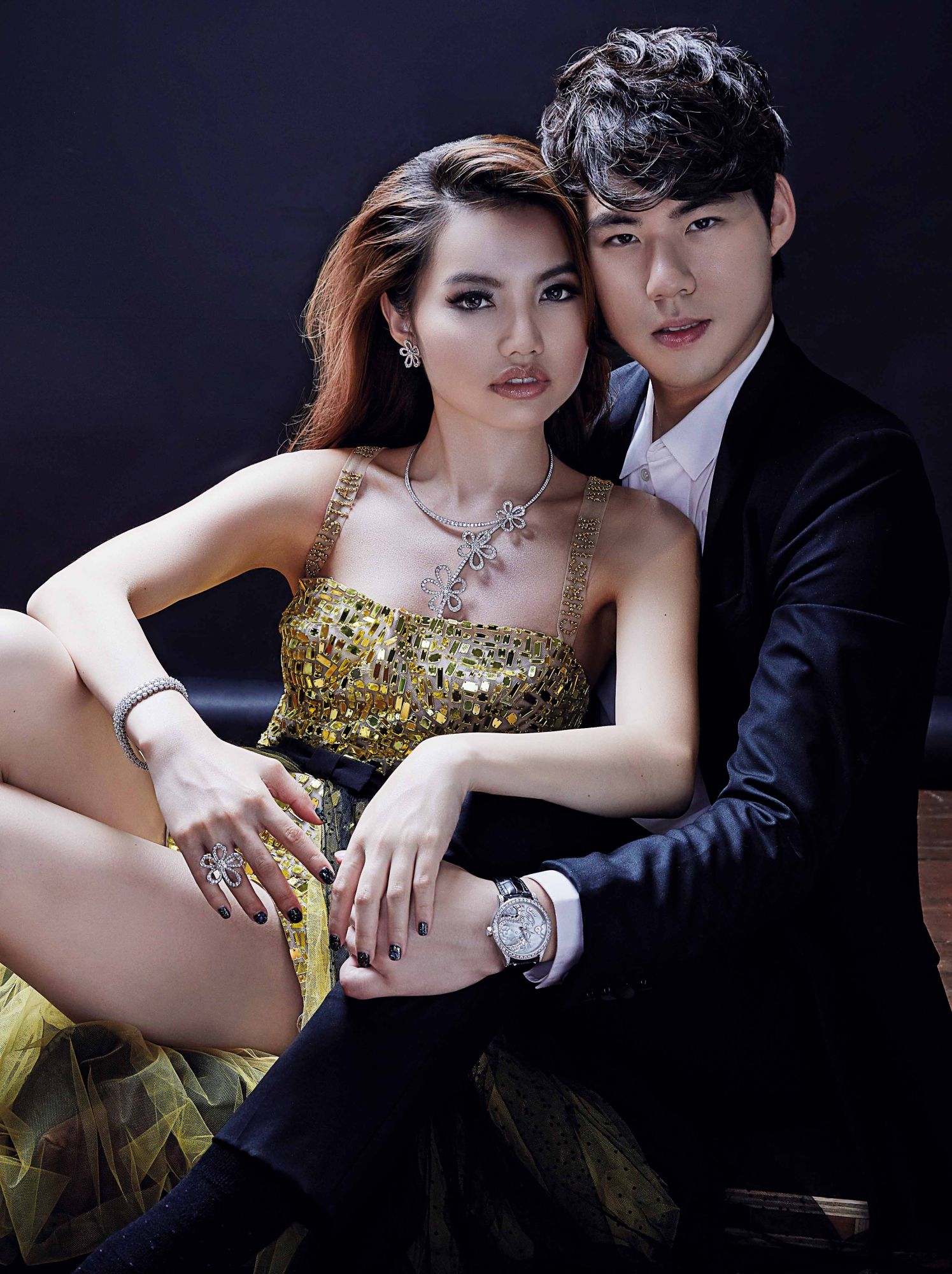 Rachel wears Flowerlace necklace, earrings and ring in white gold with diamonds, and Cheval bracelet in platinum and diamonds, all by Van Cleef & Arpels; tulle romper with crystals and pleated tulle skirt, both by Dior; Ken wears Midnight Dragon Air watch in white gold with diamonds and mother-of-pearl by Van Cleef & Arpels; suit and shirt, both by Ermenegildo Zegna