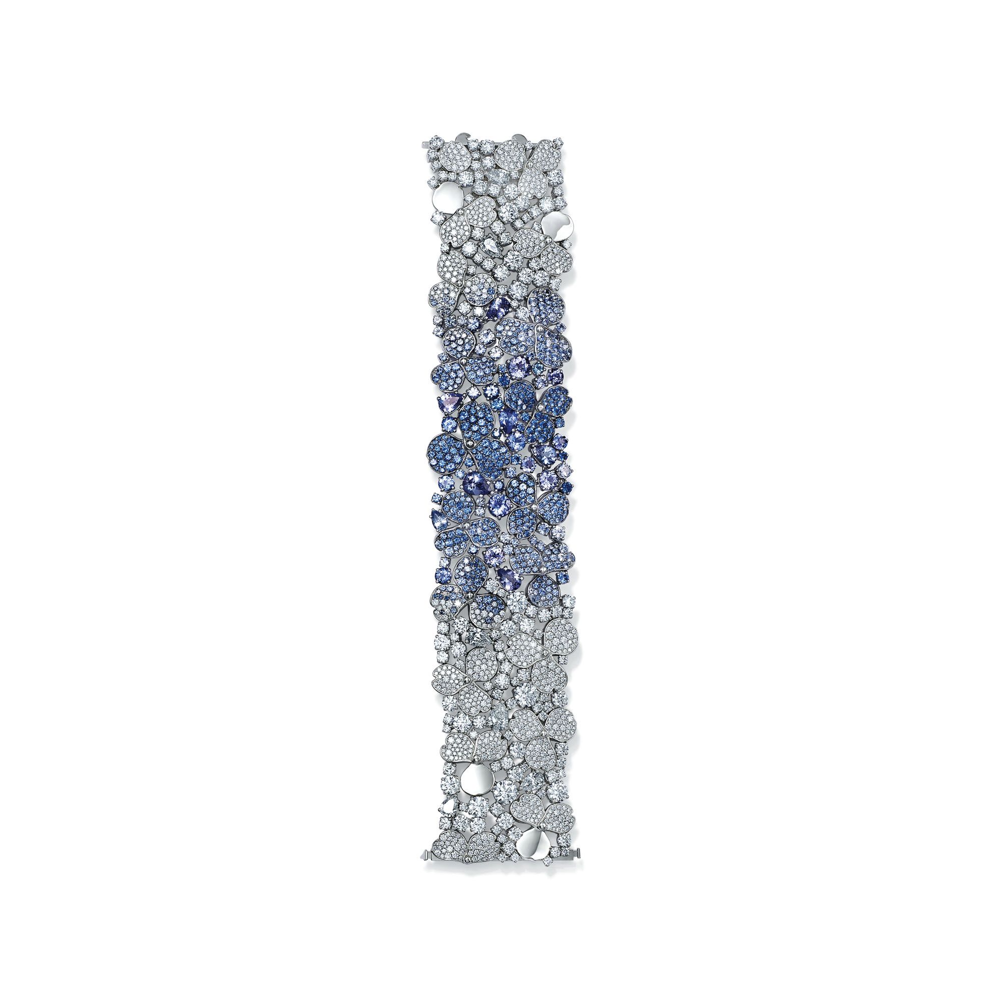 The bracelet features a combination of polished platinum petals, brilliant diamonds, as well as round- and pear-cut sapphires and tanzanites to create a complex series of contrasting textures and colours