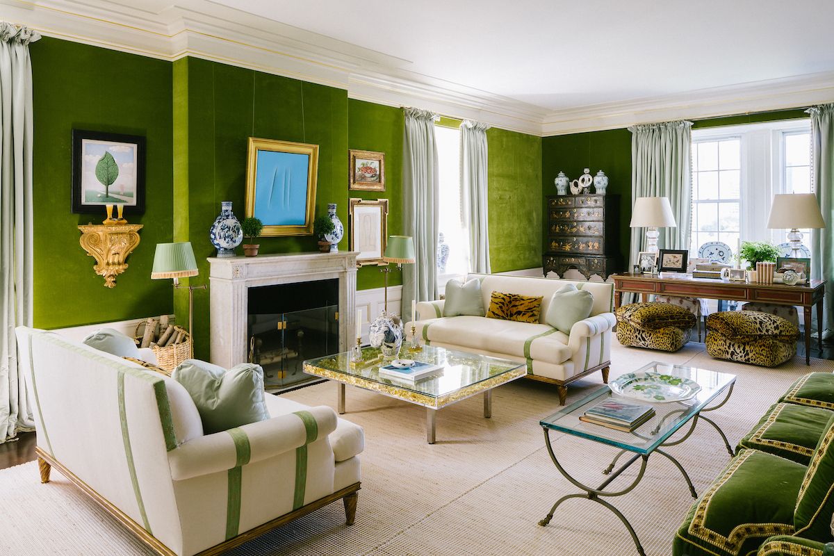 Artfully layered furnishings, each in vibrant shades of red, orange or green, sit by opulent wallpaper or deco-style monochrome walls at Tory Burch's apartment.