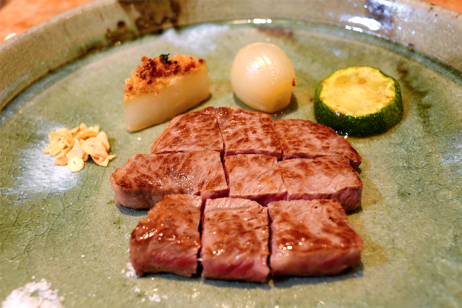 Japanese wagyu beef fillet with turnip, zucchini, small onion and fried shallot, served with peanut butter garlic sauce, ponzu sauce and grated radish
