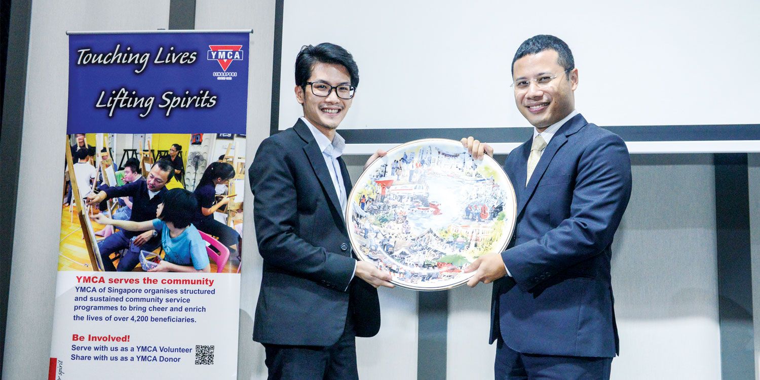 Gerald Tay, winning bidder of the Golden Jubilee Plate receiving the item from Guest-of-Honor Desmond Lee