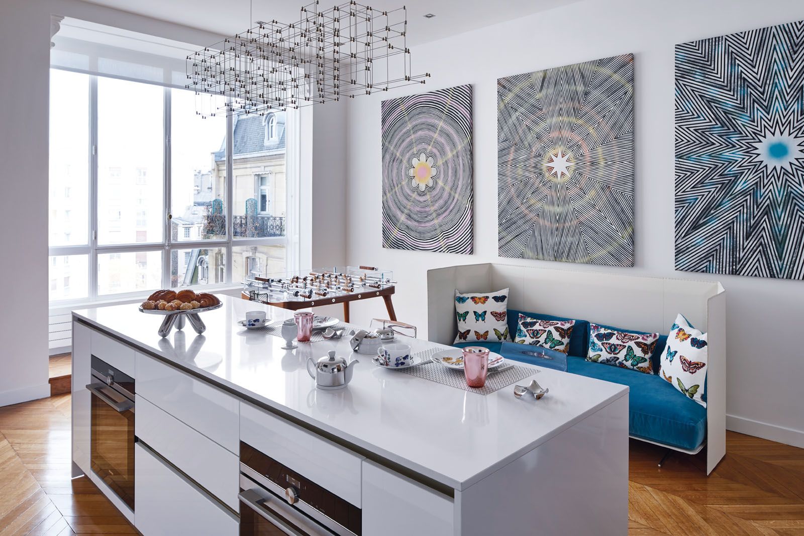 A Flexform sofa and accent cushions create a cosy corner in the kitchen