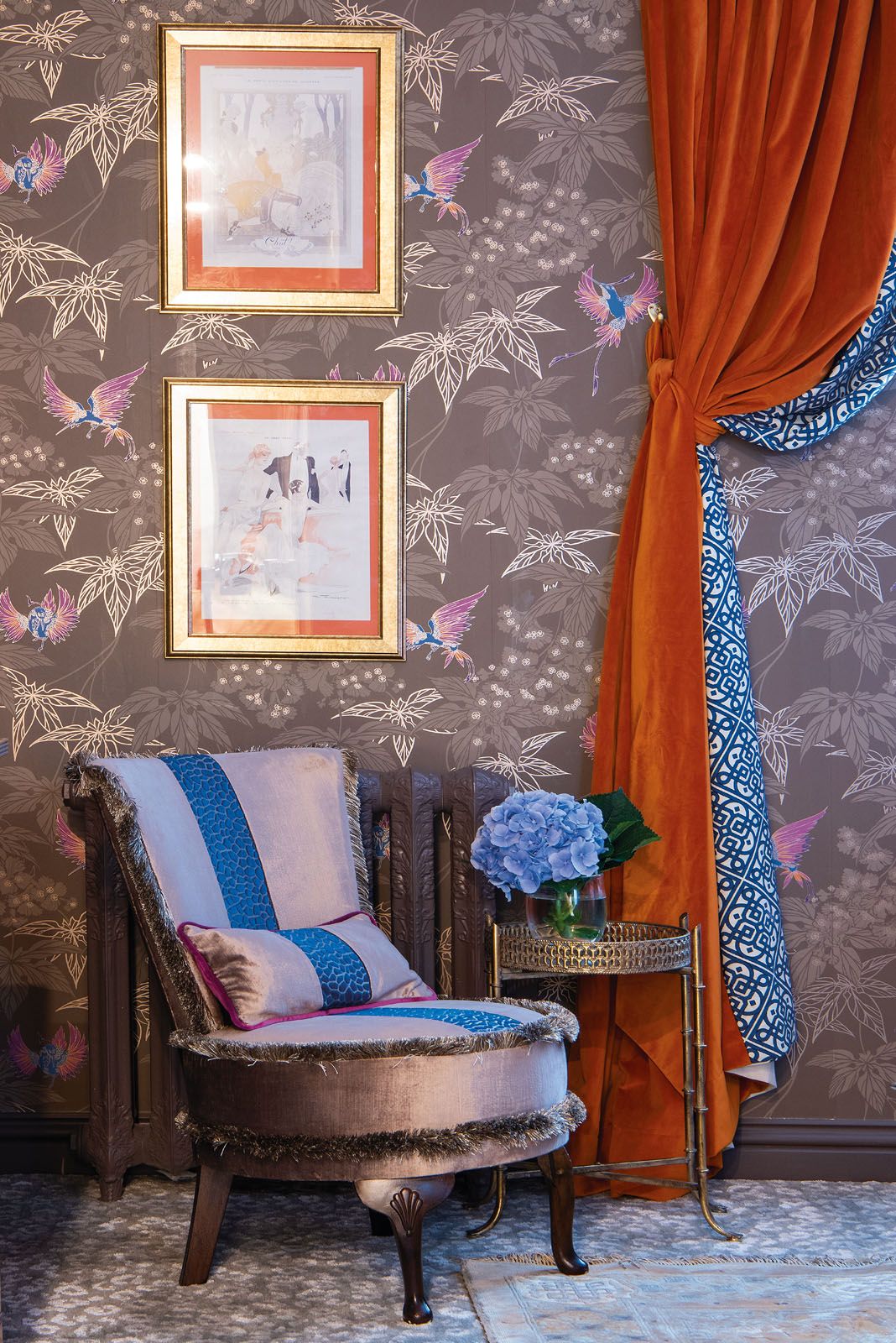 A colourful flock of birds on the wallpaper adds a lively flourish to the space
