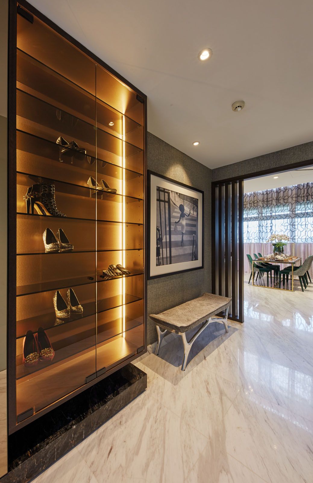 A sleek cabinet displays the wife’s collection of shoes