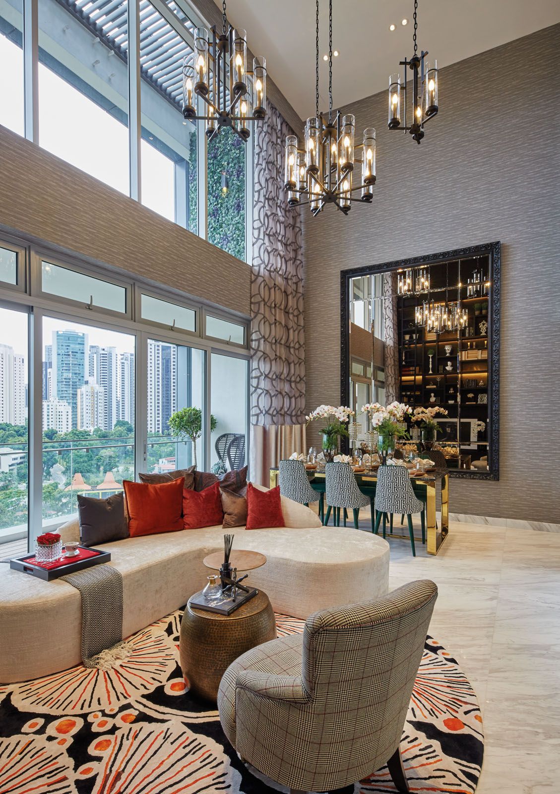 Various patterns and colours on the upholstery and rugs enliven the living and dining areas of the penthouse