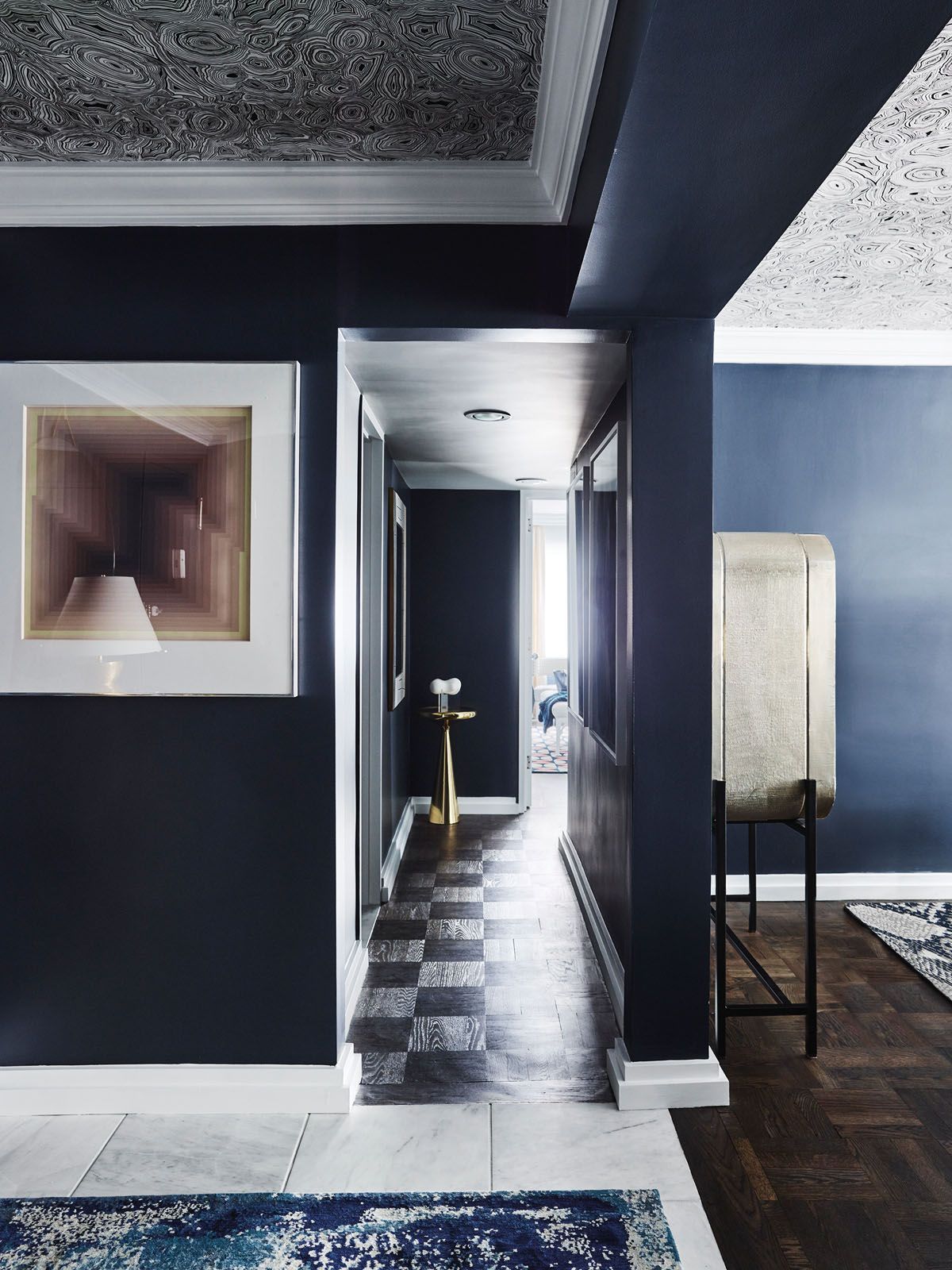 The floors feature black-stained oak parquetry, which takes on dramatically different looks according to the light
