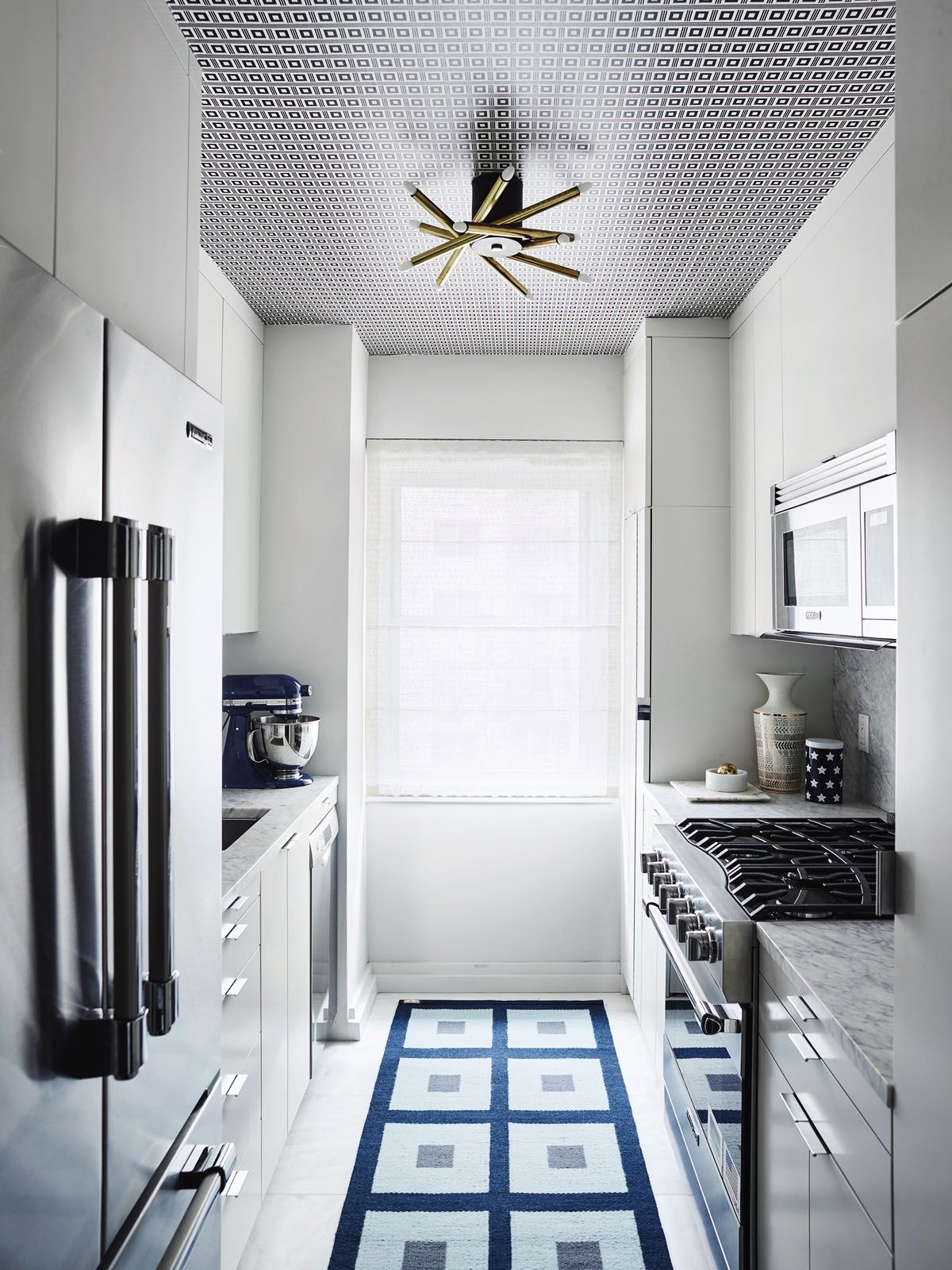 A blue rug enlivens the minimalist kitchen