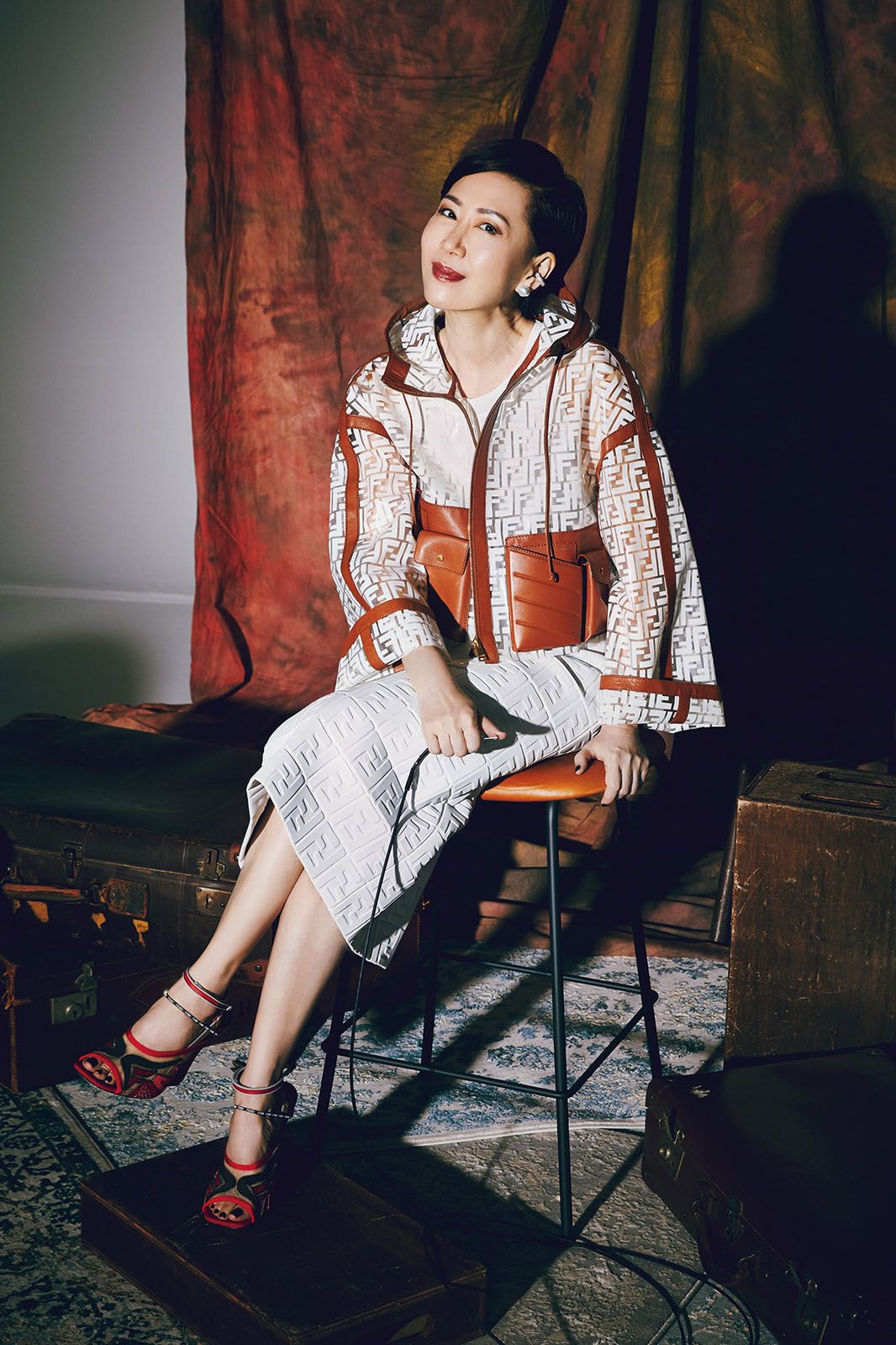 Nancy wears polyurethane jacket with leather pockets, kappa leather skirt, crystal ear cuff and Freedom technical mesh sandals, all by Fendi; blouse, Nancy's own