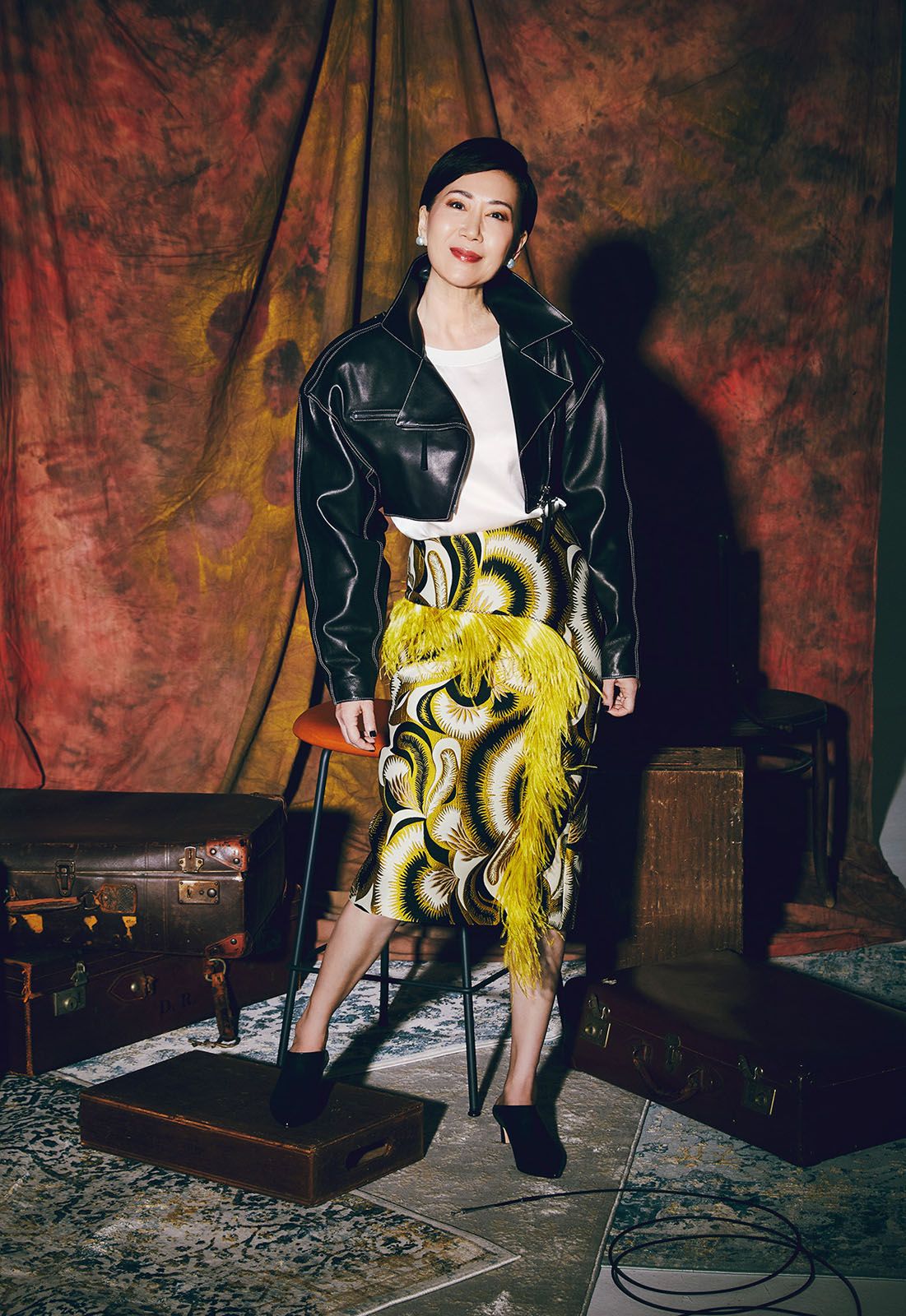 Nancy wears Marni jacket, Emporia Armani blouse, Dries Van Noten skirt, Stuart Weitzman heels and Papally earrings, all Nancy's own; crystal ear cuff by Fendi